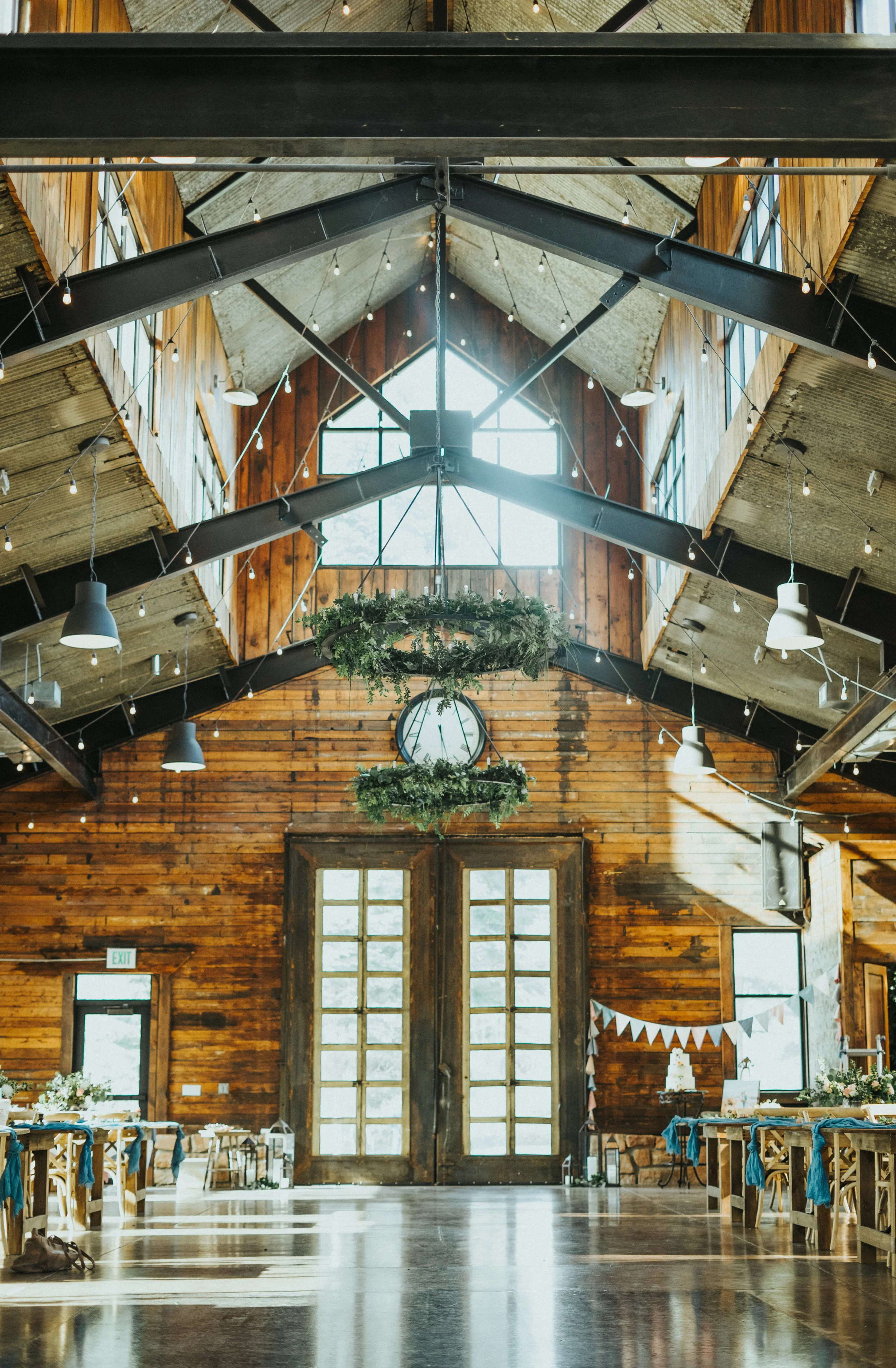  knot and pine alpine barn reception center rustic dramatic wedding large windows candle lit reception dinner rehersal dinner string lights pastel floral arrangements northern utah wedding photographer salt lake city alpine utah #northernutahweddingp
