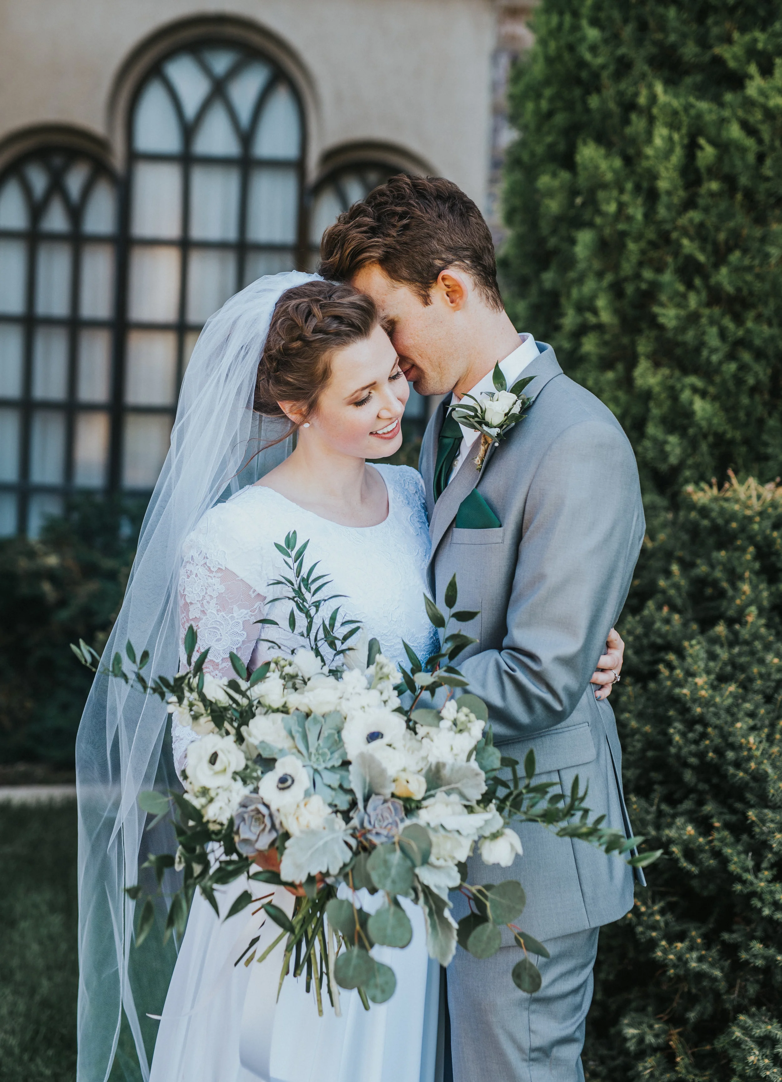  bride and groom utah wedding photographer Logan LDS temple intimate wedding photos couple posing ideas long sleeve wedding dress braided wedding hairstyles wedding bouquet lace wedding dress happy couple just married sealed for eternity grey suit #l