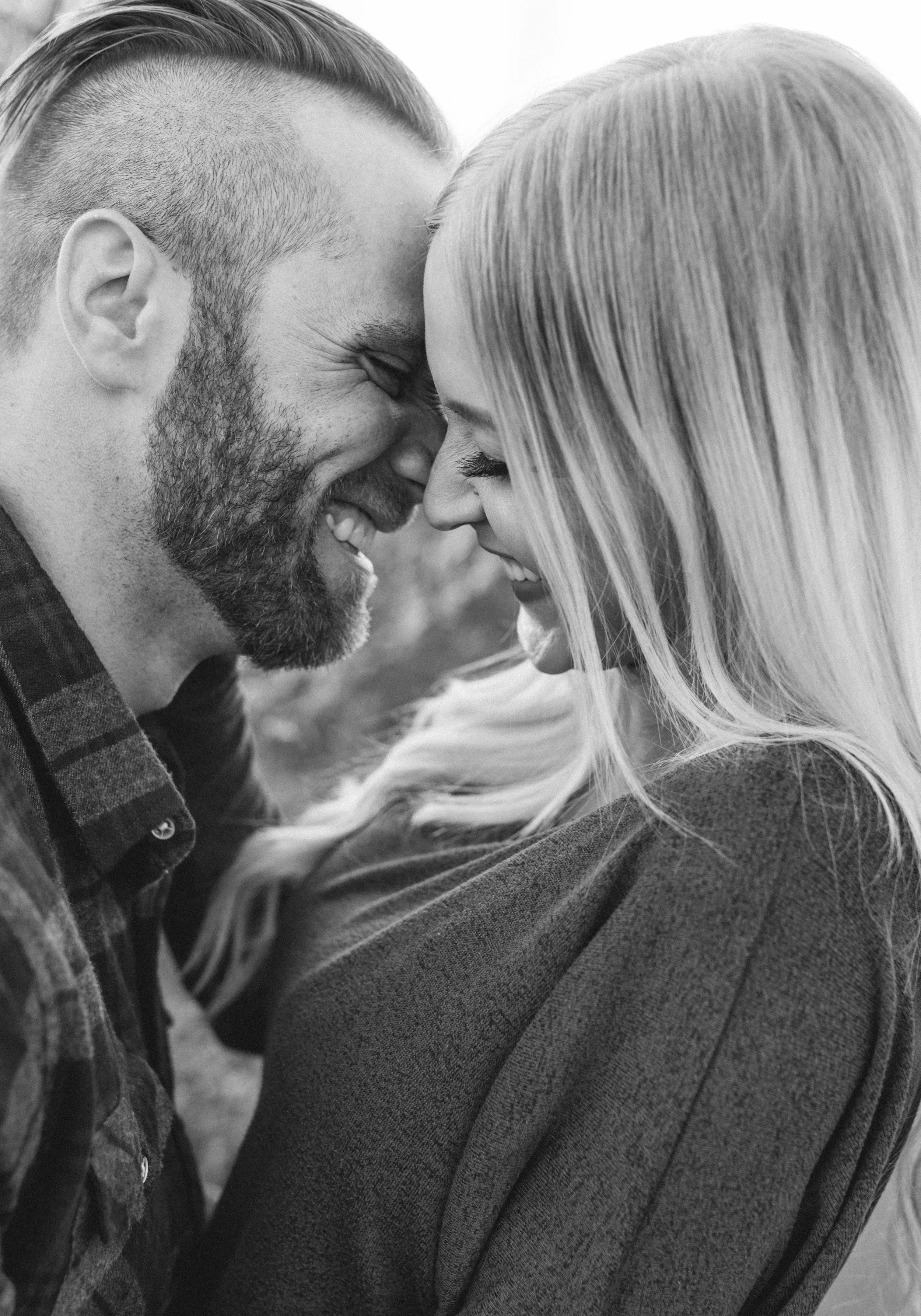  black and white engagement photos laughing playful nose crinkle faded haircut blonde hair inspiration plaid shirt northern utah engagement photographer cache valley tall grass authentic photography #engagementphotography #nothernutahphotographer #lo