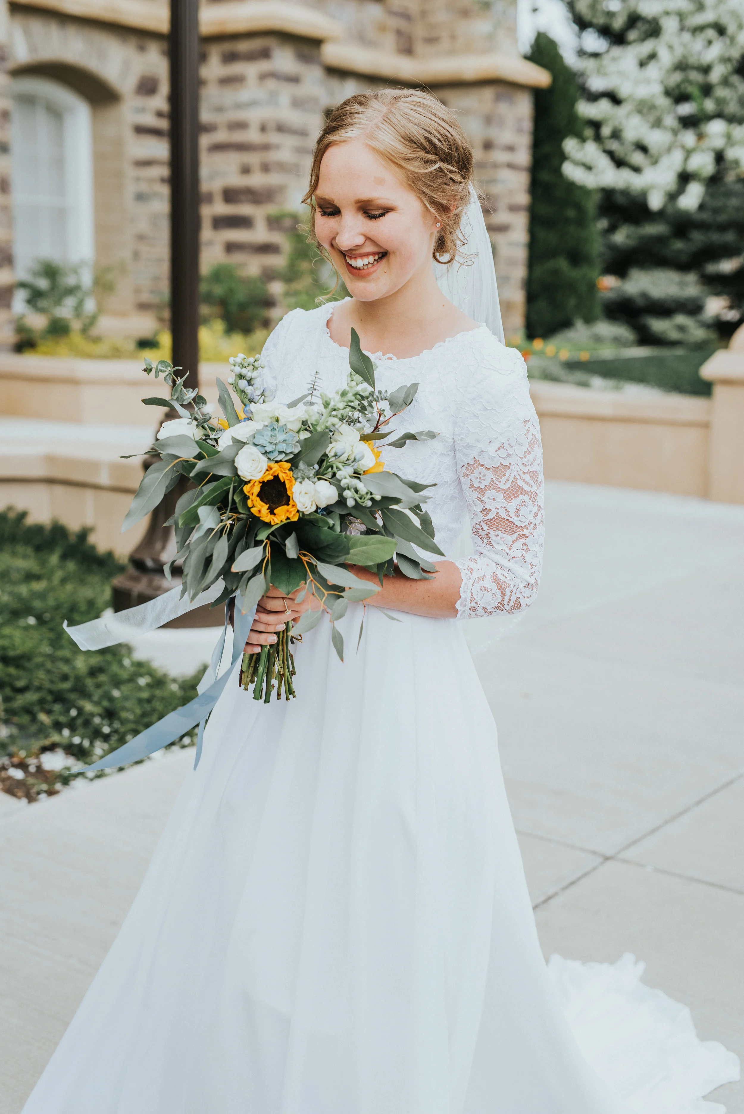  modest lace sleeved wedding dress logan utah lds temple wedding first look sunflower blue and white floral wedding bouquet temple grounds best cache valley wedding photographer wedding formals smiling bride #Loganutah #cachevalleyphotographer #Ido #