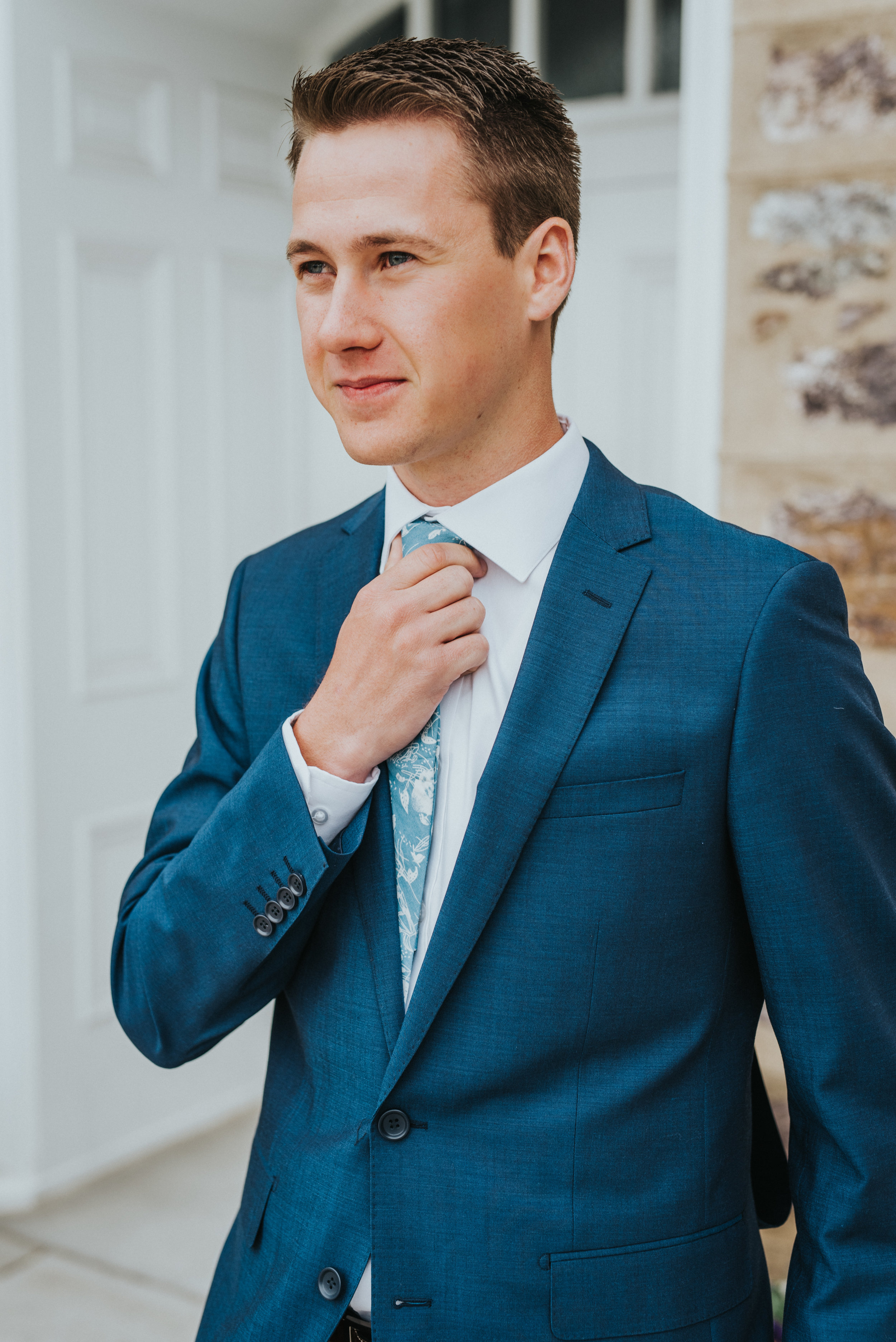  groom first look formal wedding photos blue wedding suit lds logan utah temple blue wedding tie adjusting tie best cache valley wedding photographer #Loganutah #cachevalleyphotographer #Ido #Isaidyes #weddingformals #weddinginspo #utah #utahweddingp
