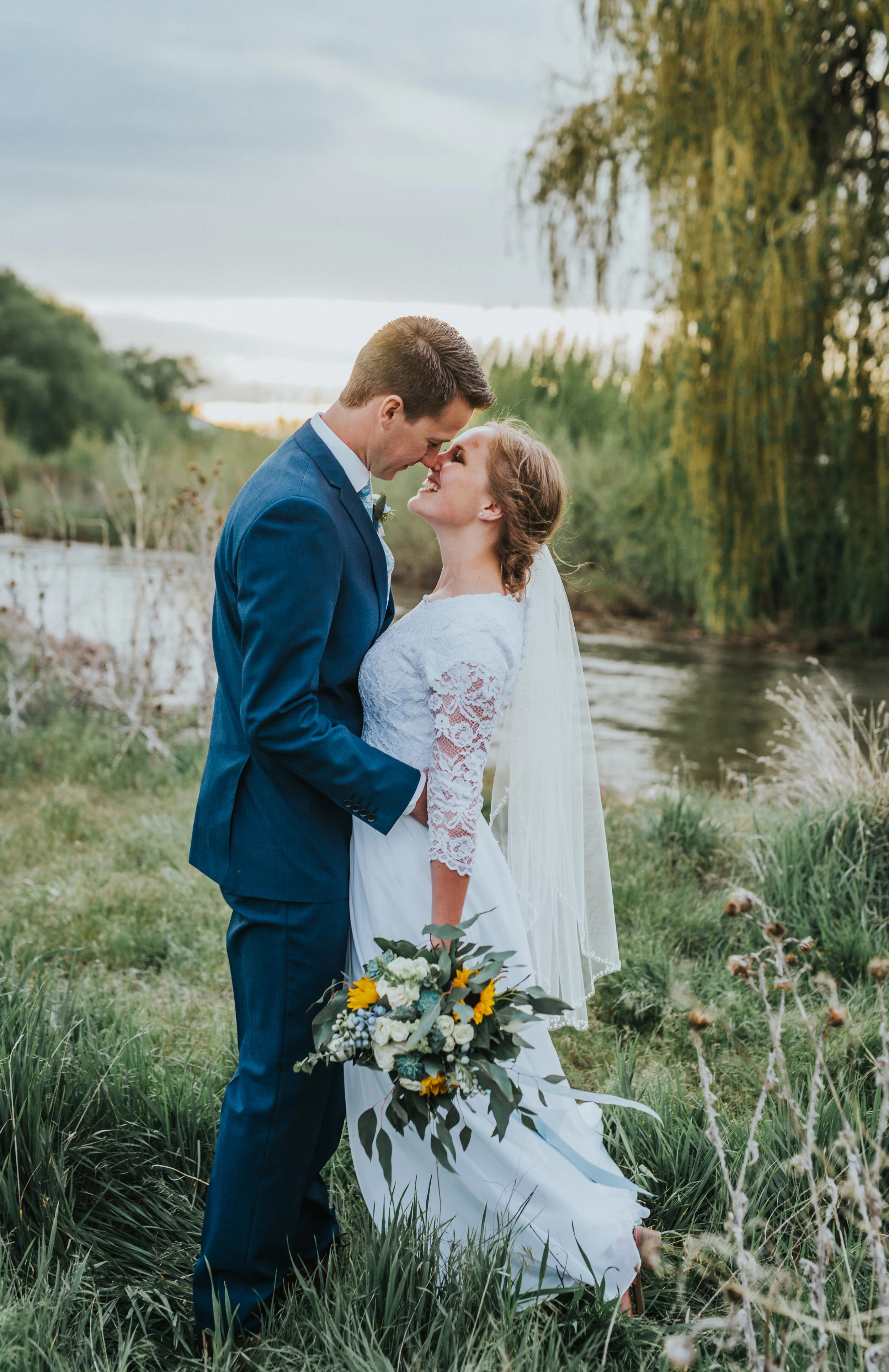  candid wedding photography hugging smiling playful touching noses stream sunset overcast gloomy skies bride and groom nature location logan utah photography locations best cache valley wedding photographer #Loganutah #cachevalleyphotographer #Ido #I