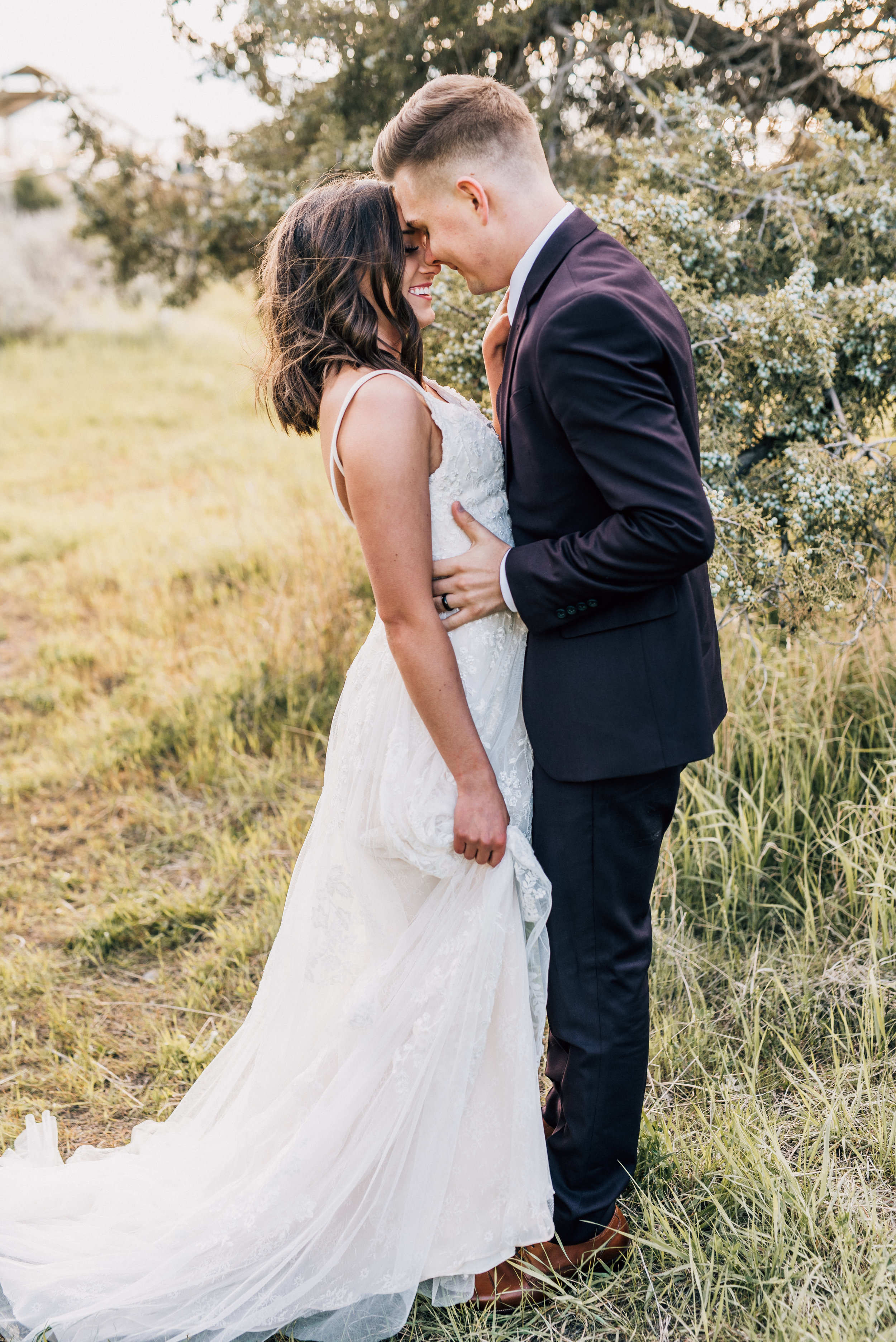  spaghetti strapped beaded wedding dress green canyon logan utah northern utah professional wedding photographer bohemian bride hugging kissing romantic outdoor bridals #greencanyon #northernutahweddingphotographer #bohemianwedding #utahbridals #wedd