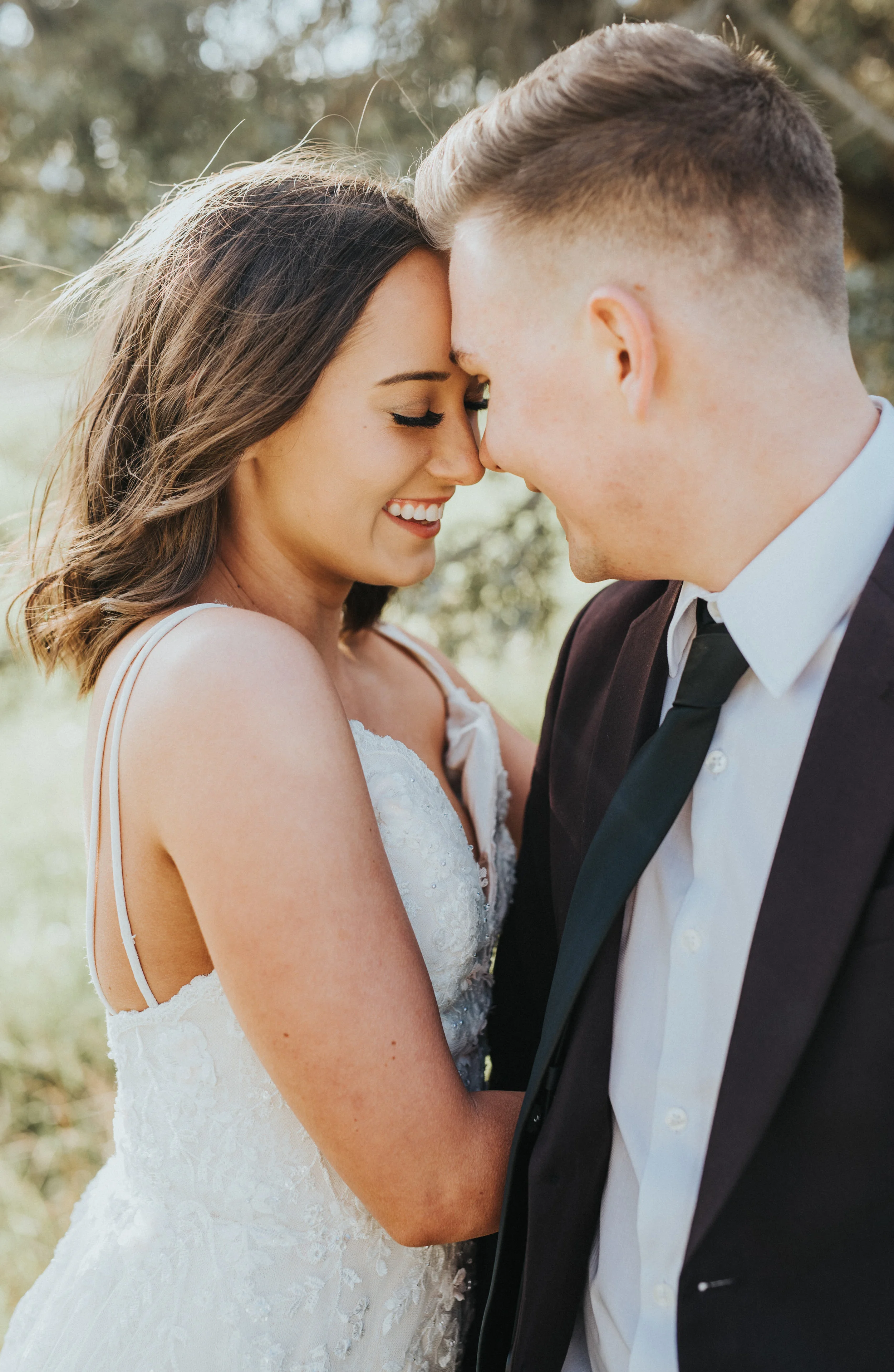  spaghetti strapped lace bohemian wedding dress sweetheart neckline wedding dress smiling laughing playful authentic bridal portraits black tie wedding suit loose curls hair inspiration northern utah wedding photographer #greencanyon #northernutahwed