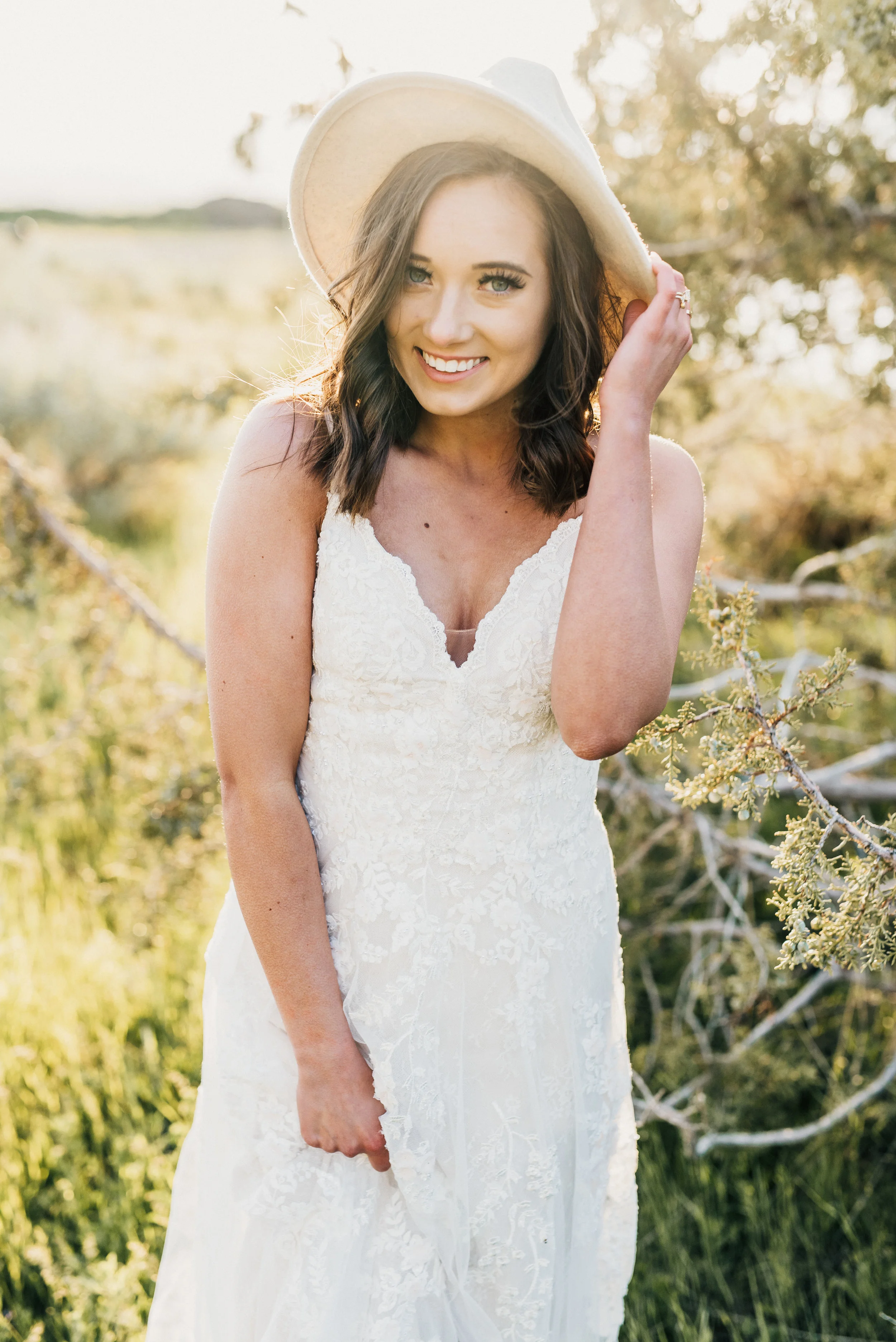  green canyon logan utah grassy field bohemian wedding fedora hat sweetheart lace wedding dress brown hair inspiration smiling authentic bridals best northern utah wedding photographer #greencanyon #northernutahweddingphotographer #bohemianwedding #u