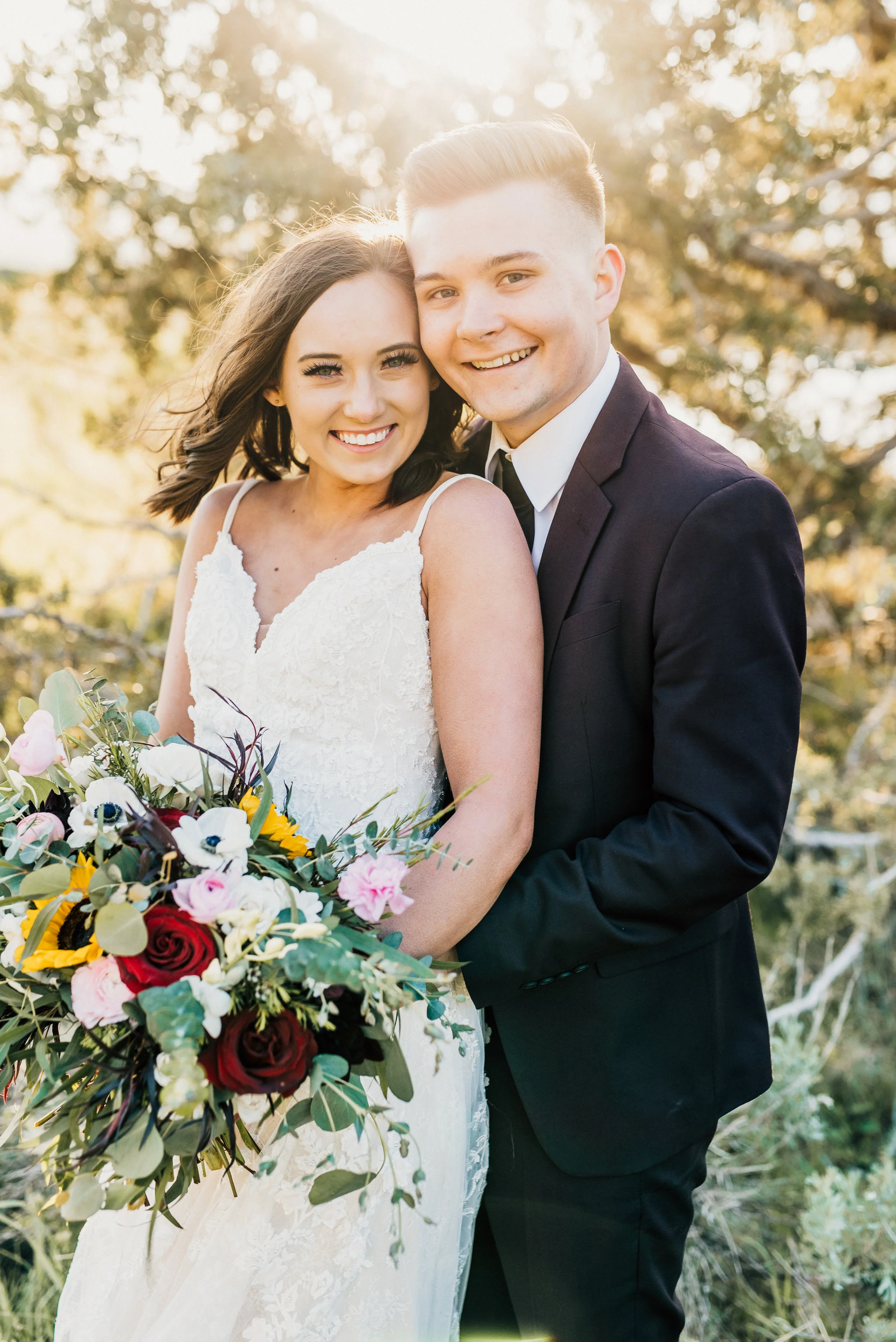  loosely gathered sunflower daisy wedding bouquet bridals smiling hugging windy curled hair bohemian bridal style romantic field northern utah wedding photographer green canyon logan utah #greencanyon #northernutahweddingphotographer #bohemianwedding