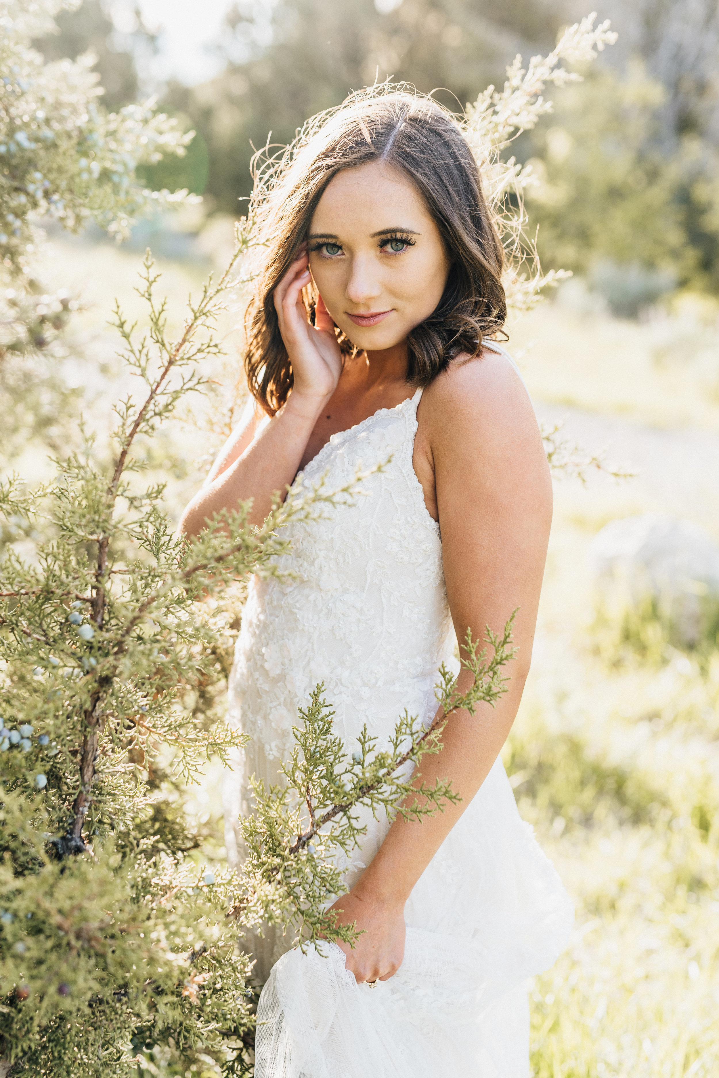  evergreen trees outdoor bridal portraits fedora bohemian white wedding dress green canypn logan utah northern professional wedding photographer beaded bodice wedding dress lace strappy dress #greencanyon #northernutahweddingphotographer #bohemianwed