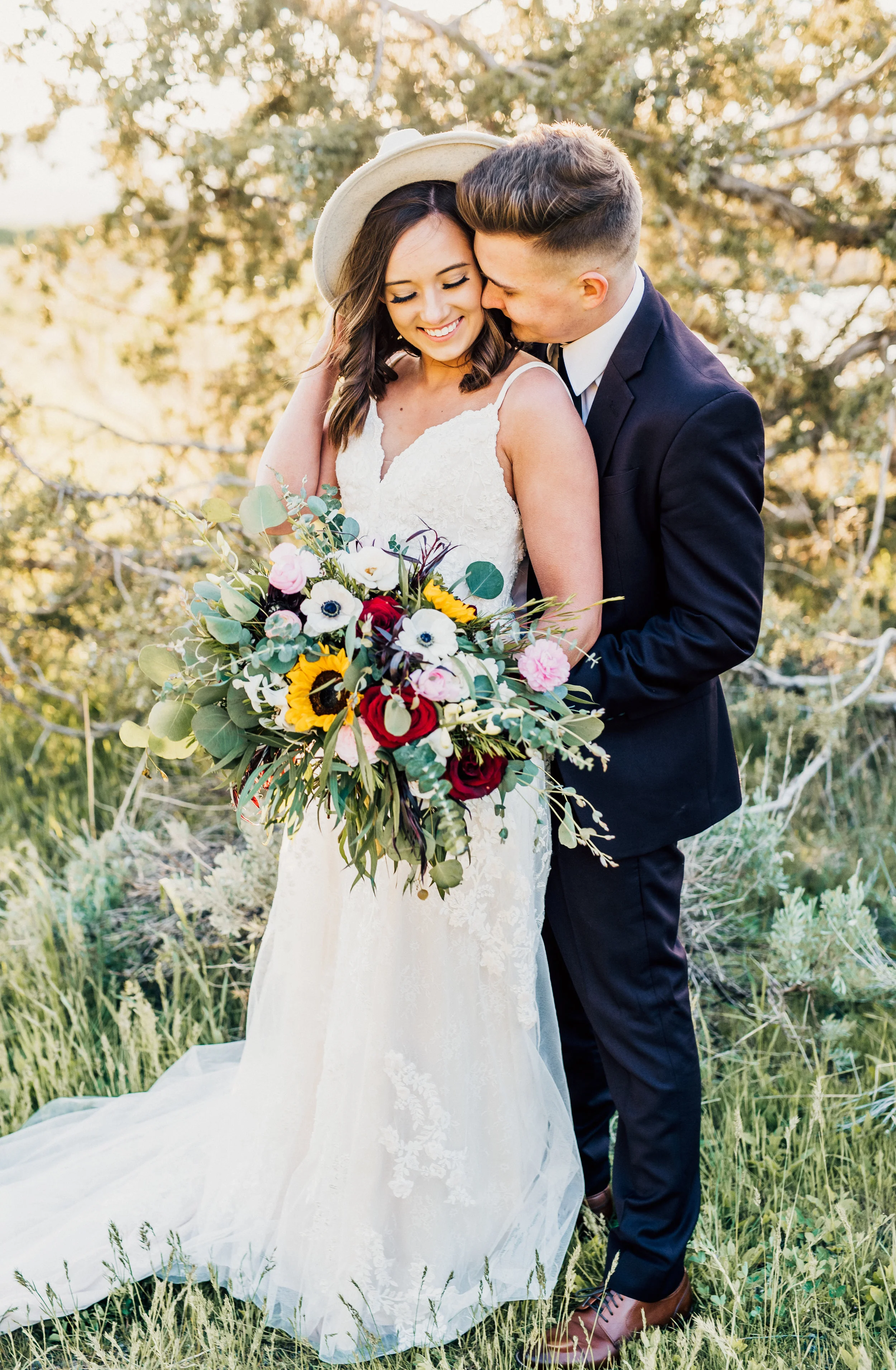  kissing cheek whispering smiling happy romantic hugging bohemian wedding outdoor bridals green fall trees loosely packed wildflower wedding bouquet northern utah wedding photographer #greencanyon #northernutahweddingphotographer #bohemianwedding #ut