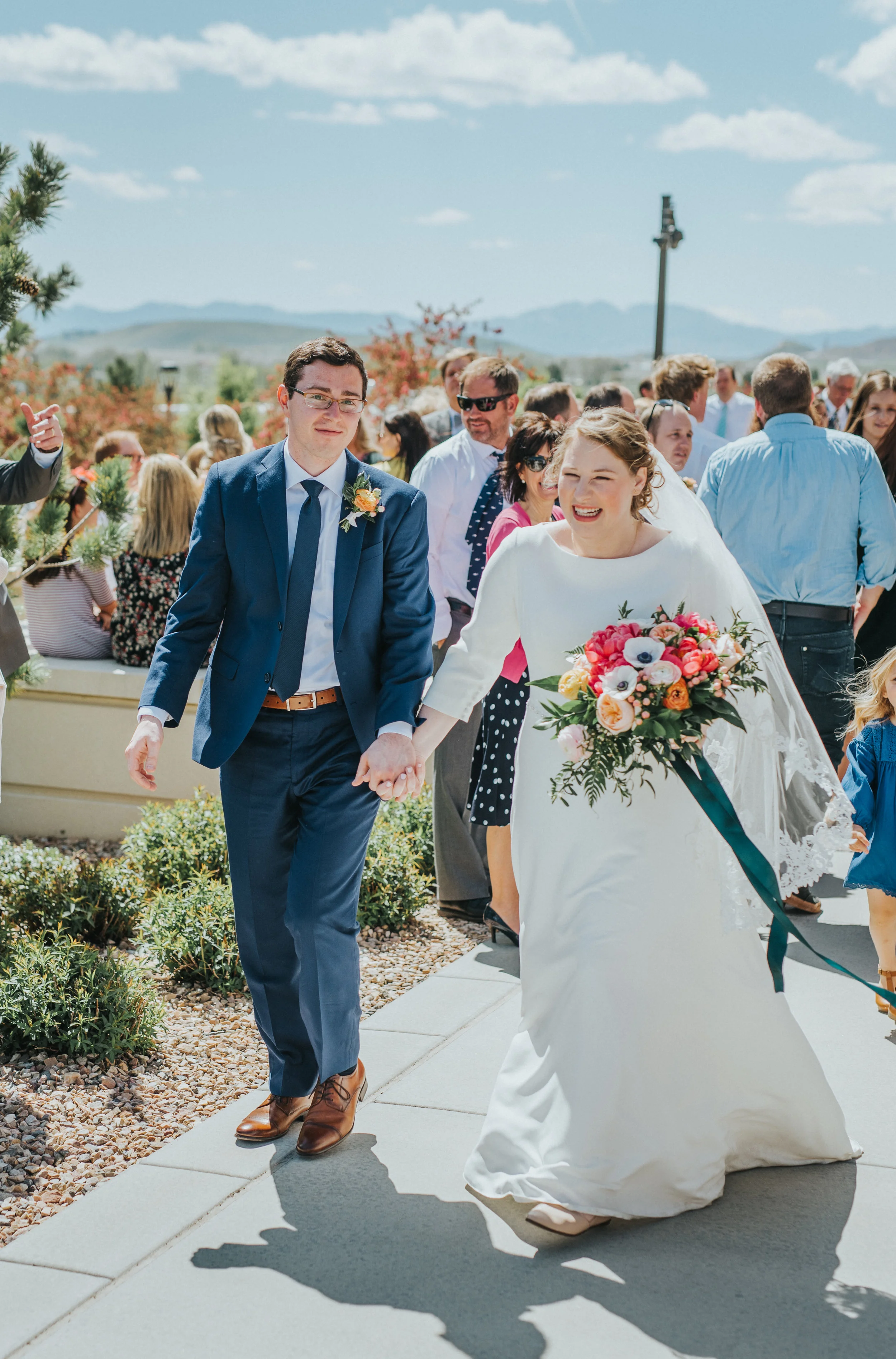  lds payson utah temple wedding bride and groom holding hands wedding exit poppy pink peach floral bouquet lace wedding veil emerald green bouquet ribbon blue wedding suit payson utah wedding photographer #professionalutahphotographer #paysonutah #no