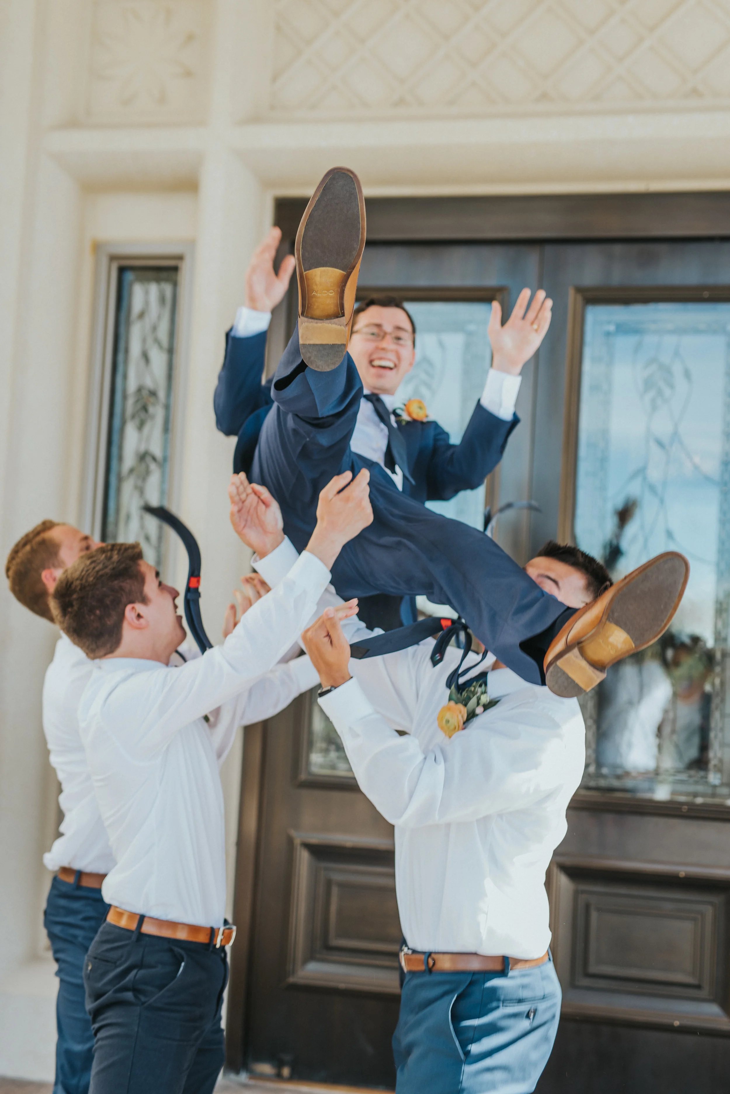  payson utah lds wedding groomsmen celebrating tossing the groom navy wedding suit happy friends best payson utah wedding photographer wedding doors boutonnieres #professionalutahphotographer #paysonutah #northamptonhouse #ido #weddinginspo #ldstempl