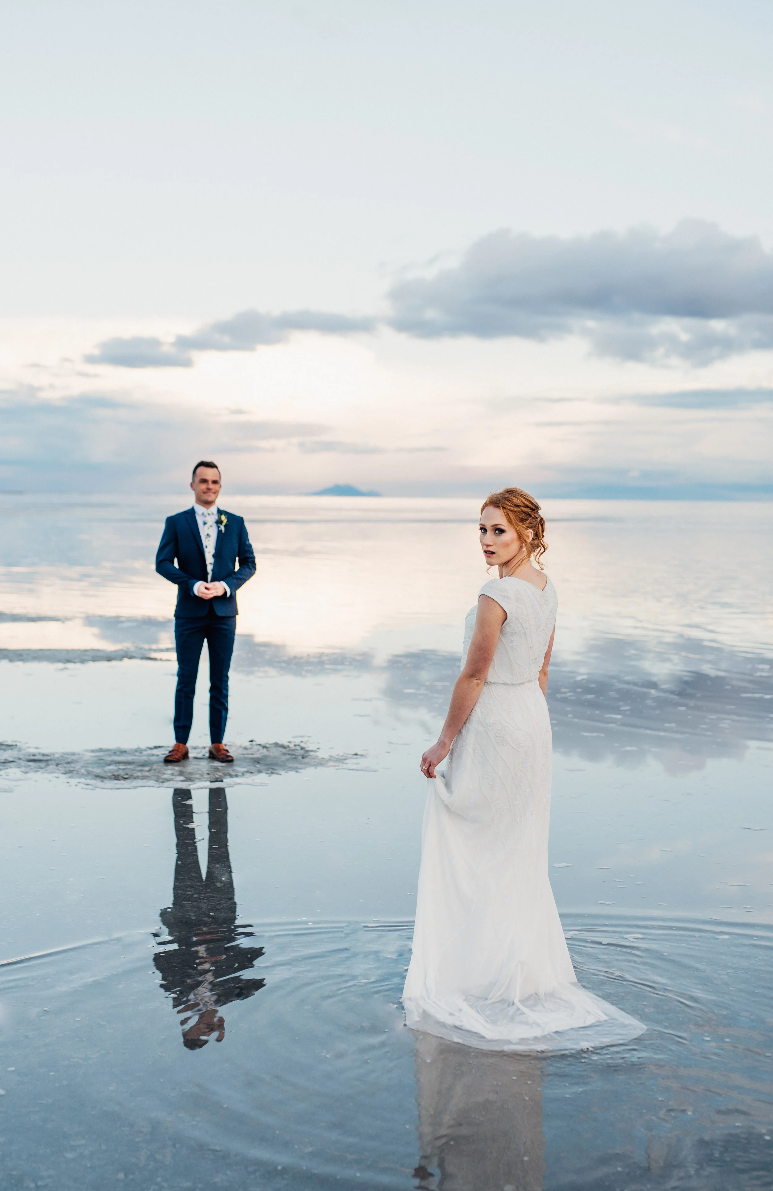  first look walking in water in wedding dress formal bridals northern utah wedding photographer salt lake city utah great salt lake cloudy sky sunset #spiraljetty #saltlakecityweddingphotographer #saltlake #ido #northernutahphotographer #bridals #wed