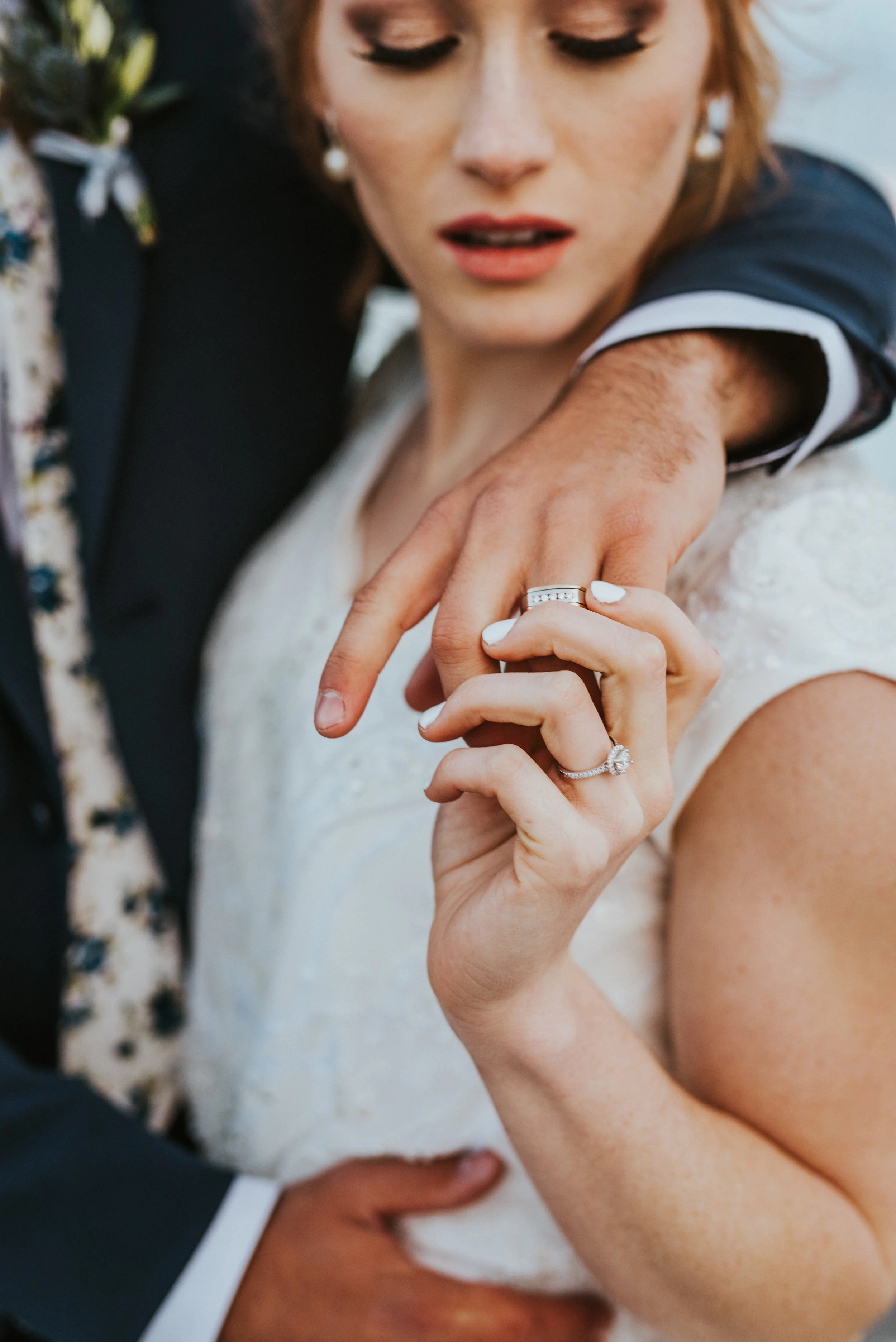 holding hands modest cap sleeved wedding dress interlocking fingers romantic bridal portraits great salt lake floral tie navy wedding suit northern utah wedding photographer professional best #spiraljetty #saltlakecityweddingphotographer #saltlake #