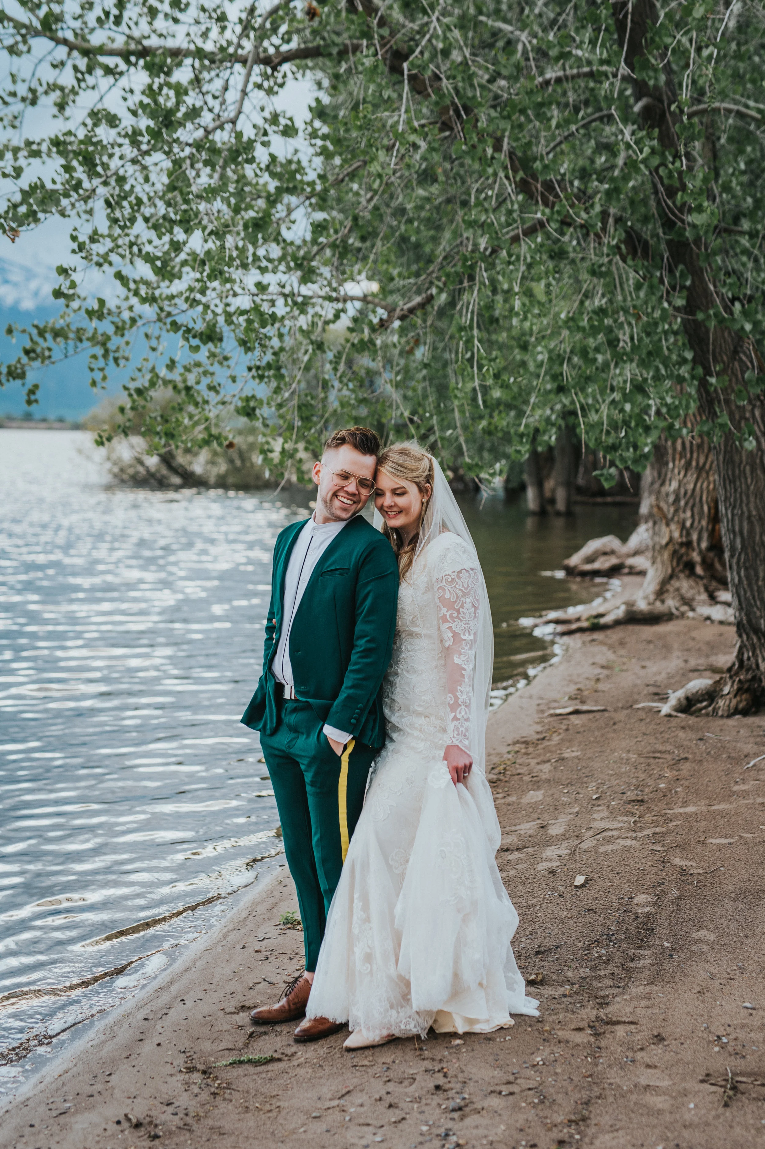 hyrum reservoir cache valley logan utah northern utah wedding photographer formals bridals laughing water sand trees romantic lighting mountain backdrop modest lace wedding dress green retro wedding suit #cachevalleyutah #hyrumutah #northernutahphot