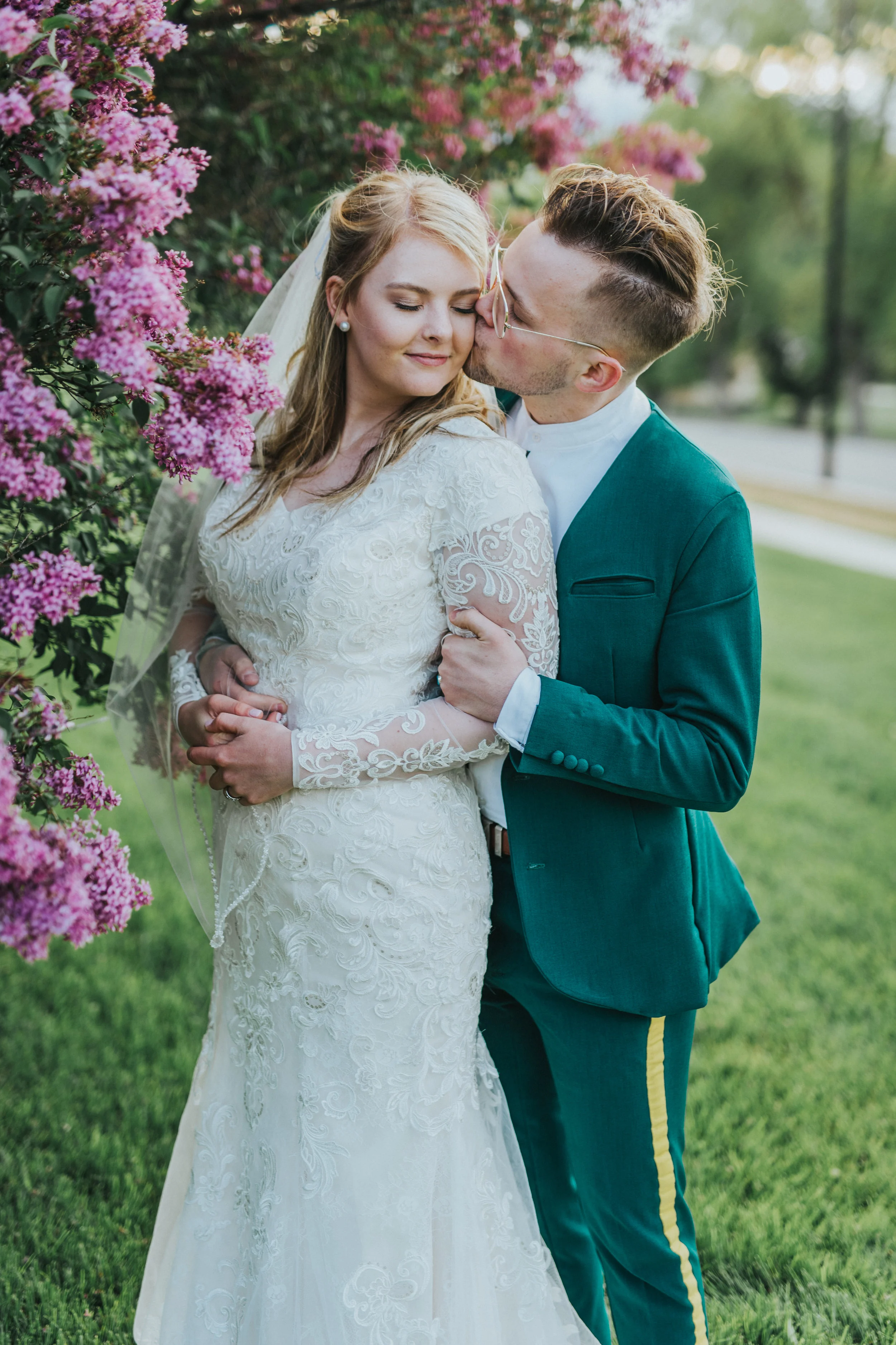  romantic kissing cheek hugging holding love formal bridals northern utah wedding photographer logan utah hyrum reservoir purple lilac tree lush greenery green retro wedding suit #cachevalleyutah #hyrumutah #northernutahphotographer #bridals #hyrumre