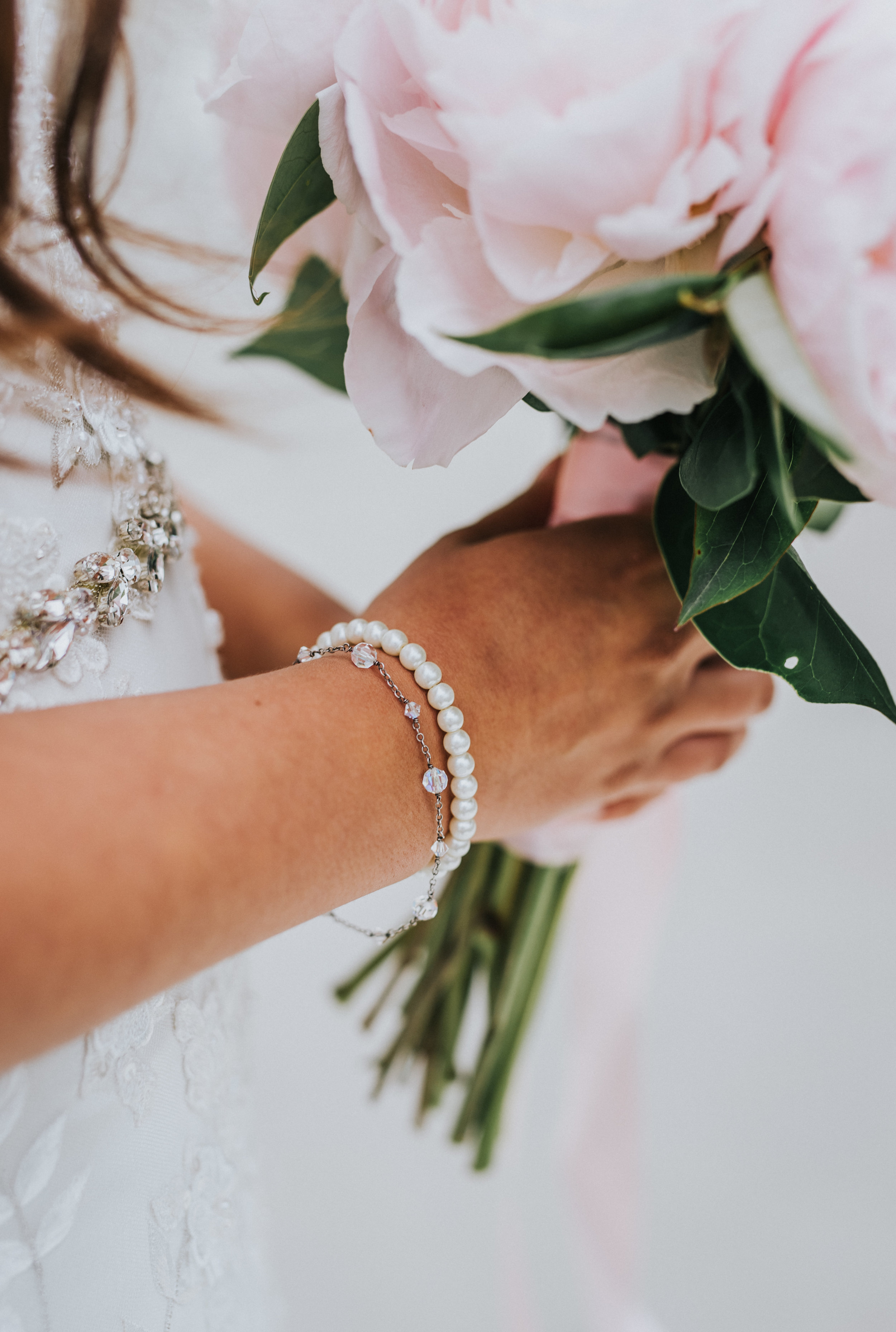  close up wedding detail bridals pink peony wedding bouquet diamond bracelet pearl bracelet diamond wedding sash san diego wedding photographer formal photos bride #lajollacaliforniaweddingphotographer #sandiegotemple #windanseabeachcalifornia #north