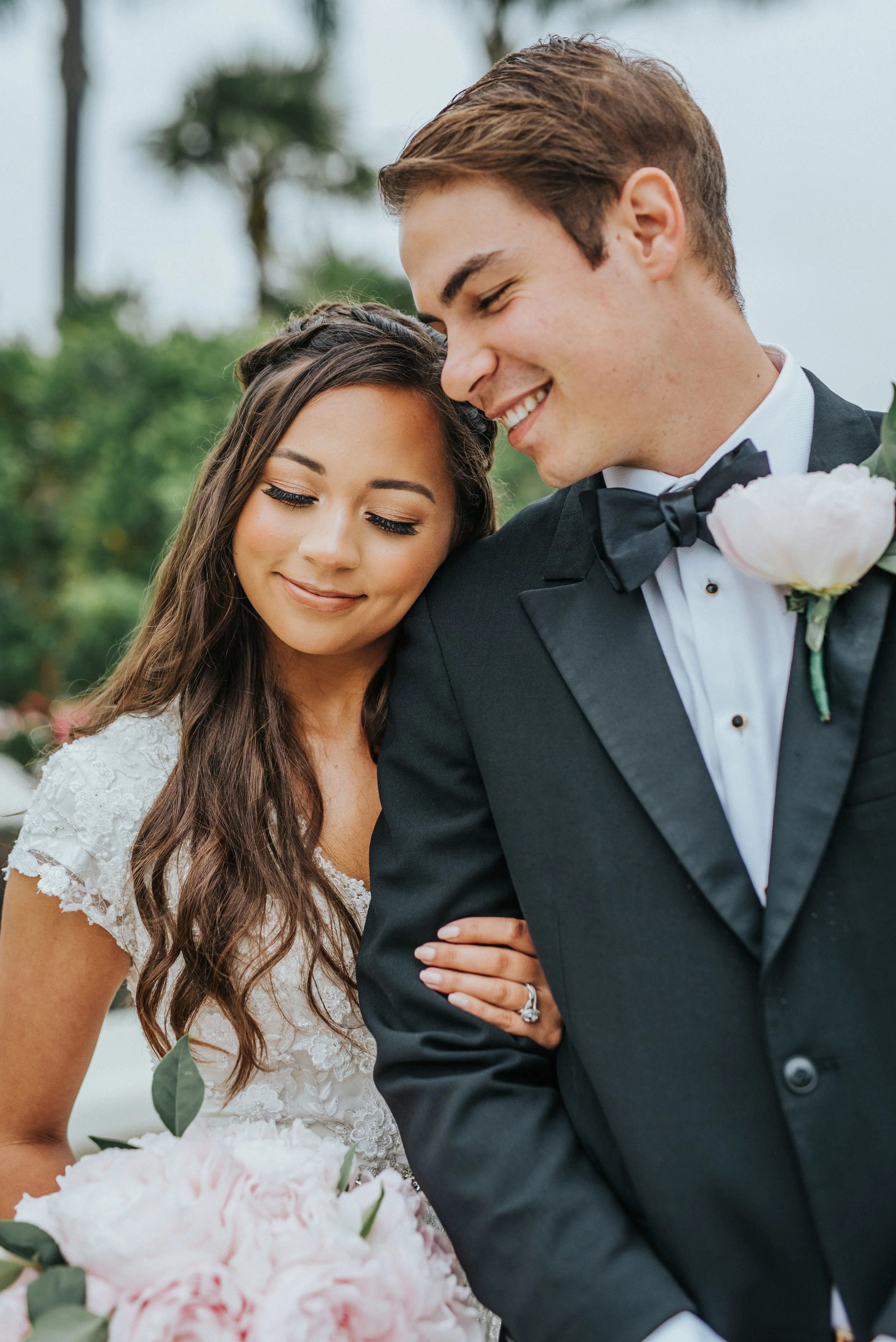  cap sleeve beaded wedding dress loose brown wedding curls hugging happy smiling natural bronzed wedding makeup groom black suit pink boutonnière romantic northern utah wedding photographer san diego california wedding photos #lajollacaliforniaweddin