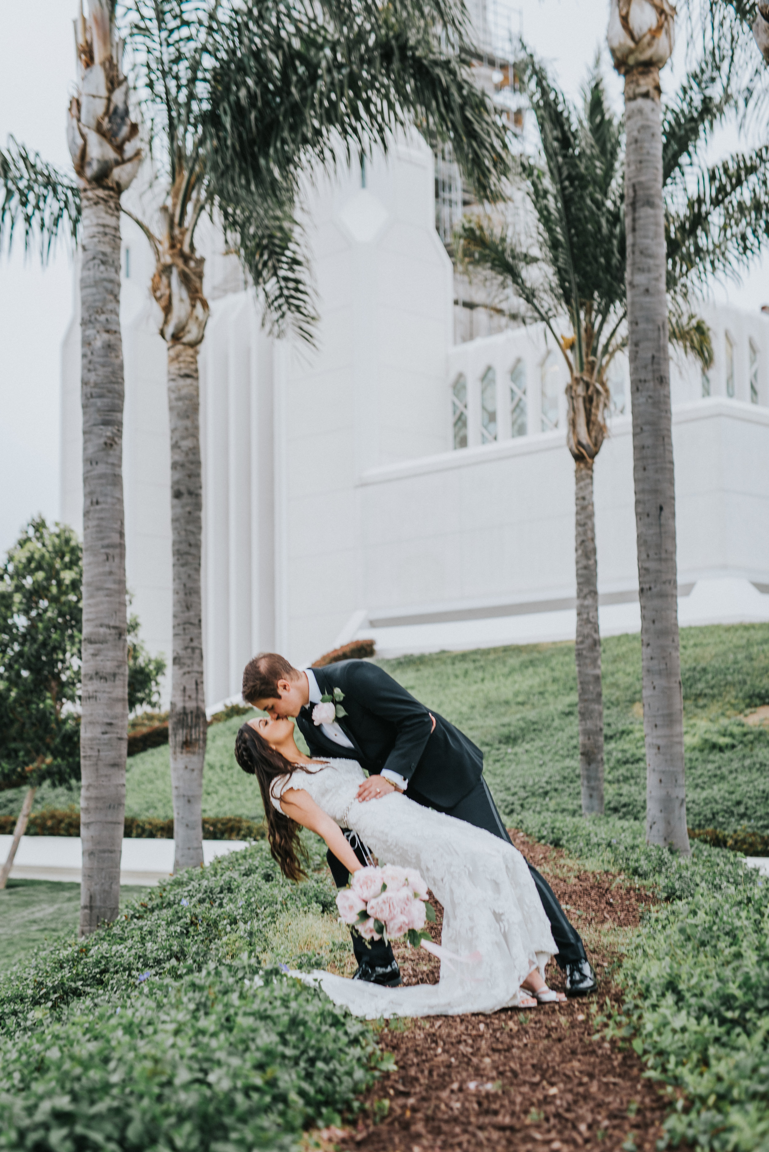  kissing dipping hugging romantic san diego lds temple grounds palm tree wedding photos bridals pink peony wedding bouquet soft pink northern utah wedding photographer san diego wedding photography #lajollacaliforniaweddingphotographer #sandiegotempl