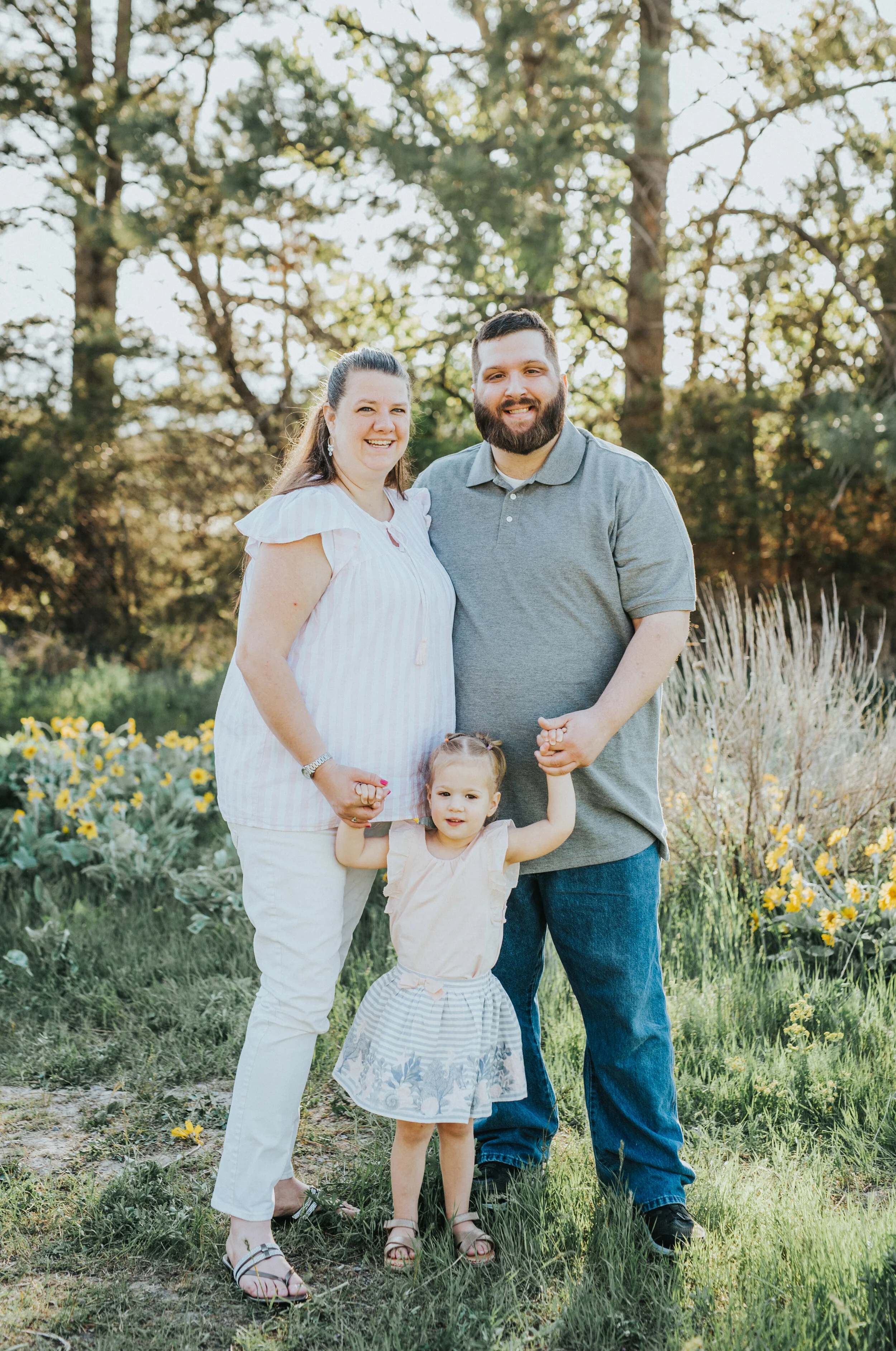  logan utah family photography utah photographer extended family photography session sunflowers family of three small family posing idea for three people husband and wife family holding hands semi formal outfit inspo spring color outfit inspo family 