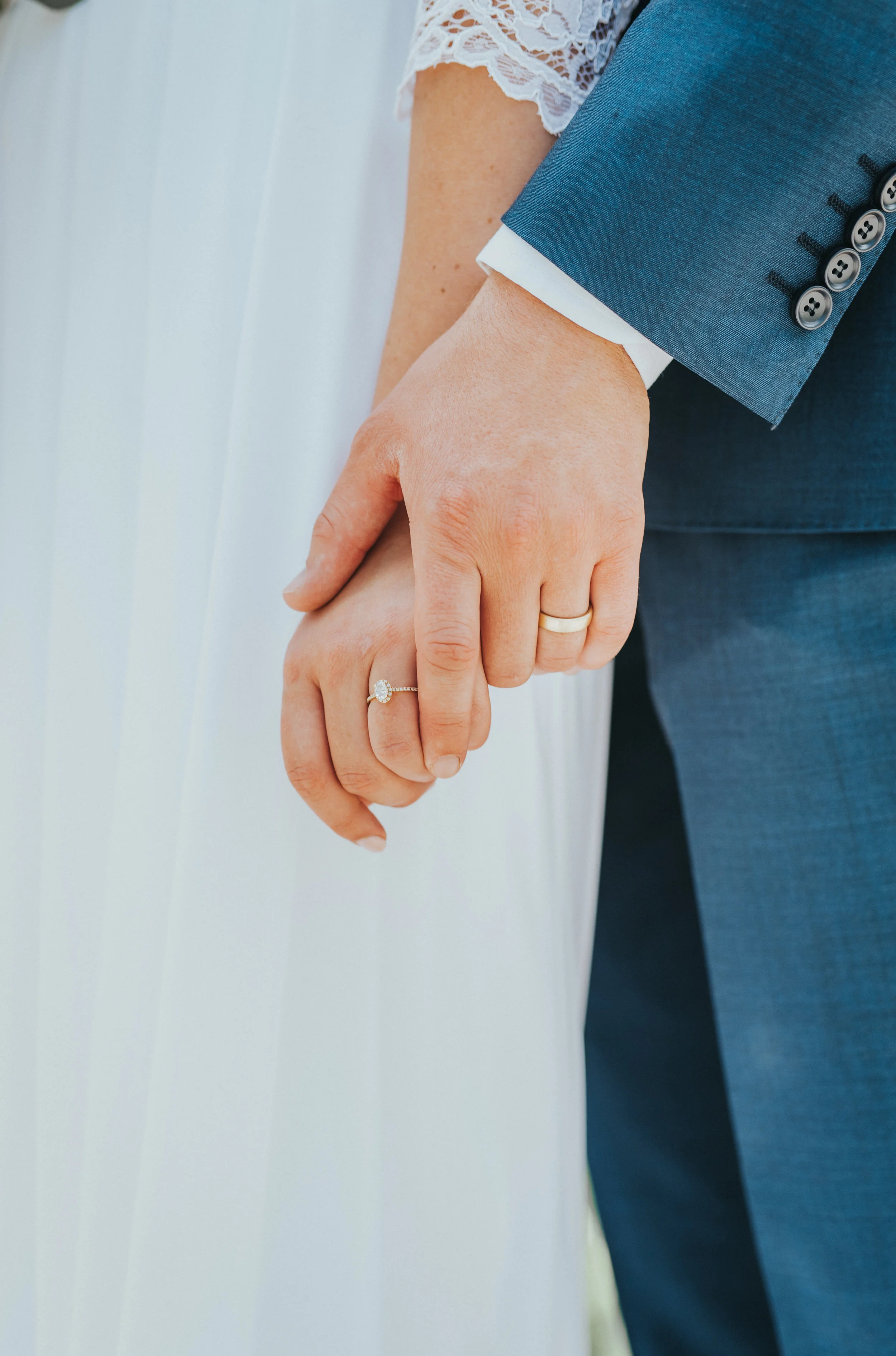  teardrop halo wedding ring wedding bands photo three quarter sleeved lace wedding gown blue wedding suit hand holding natural wedding poses professional logan utah wedding photographer old rock church wedding venue #Loganutah #cachevalleyphotographe