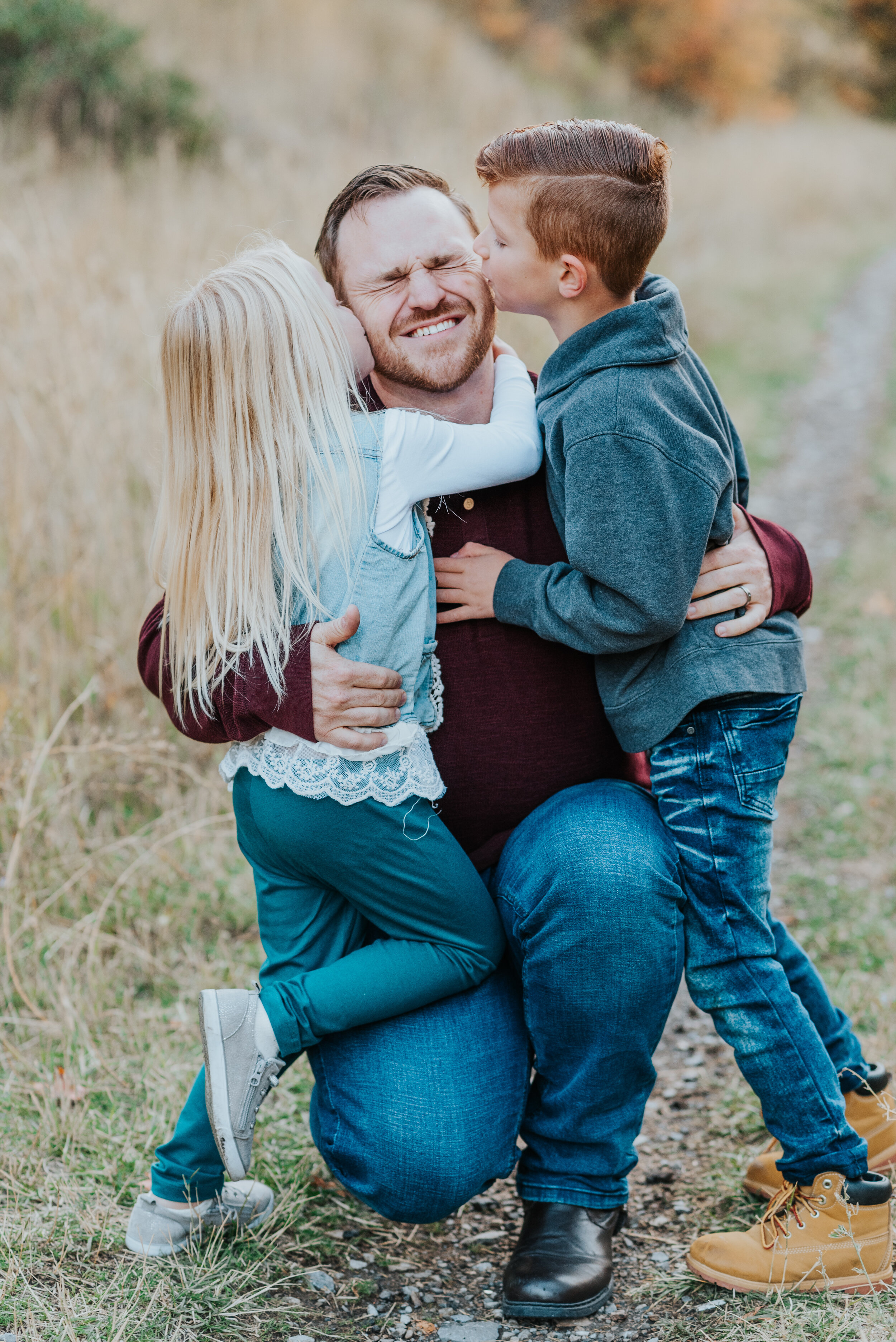  family photos family of three fall photoshoot fall outfit inspiration what to wear to family photos dad and kids brother and sister kids kissing dad candid moments silly moments real life moments happy family family posing ideas family of three posi