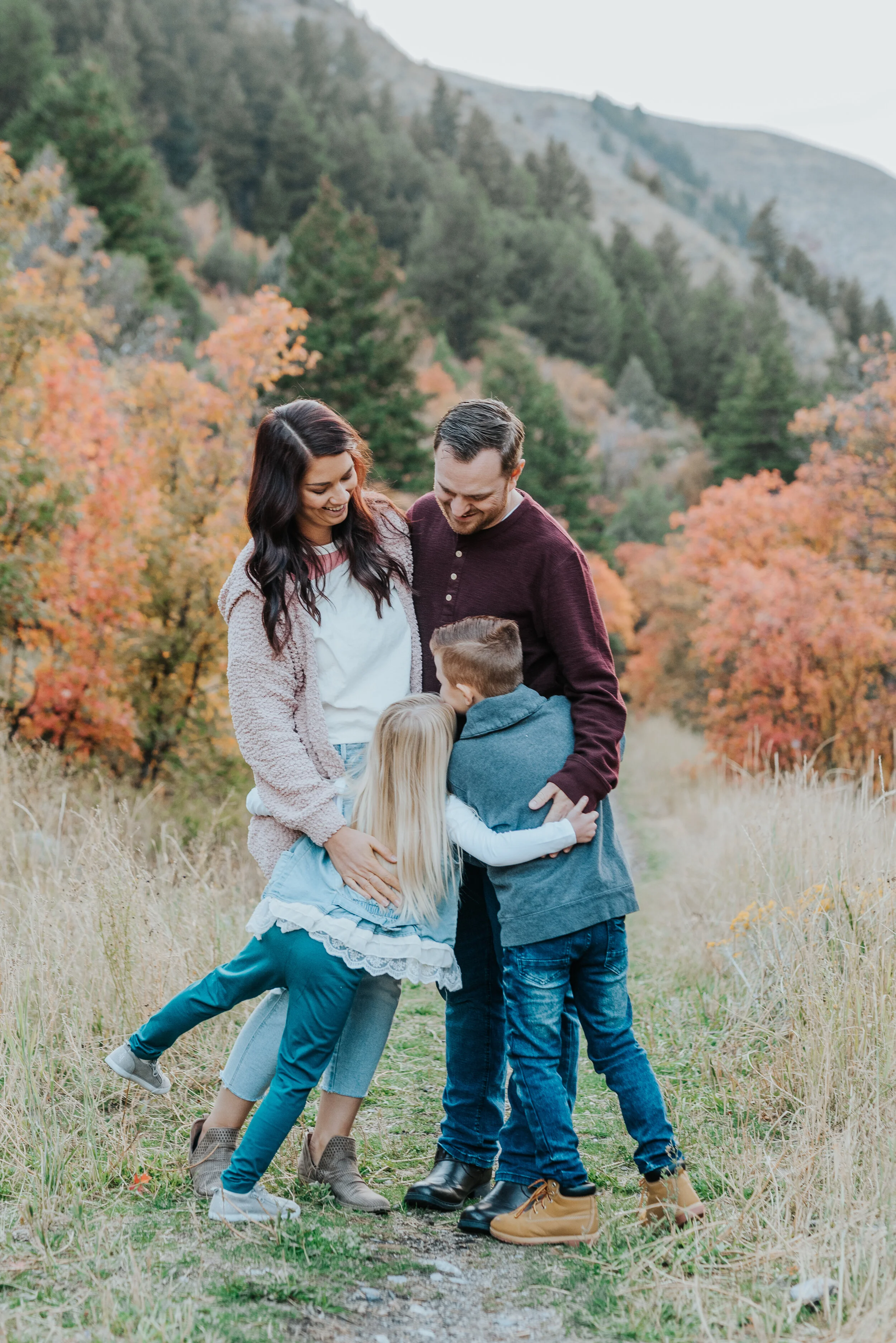 fall family photos cache valley family of four family posing ideas family of four posing inspo candid moments real moments capture love lovely family fall leaves colorful photos family photography laughter sill moments hugging siblings hugging mom a…
