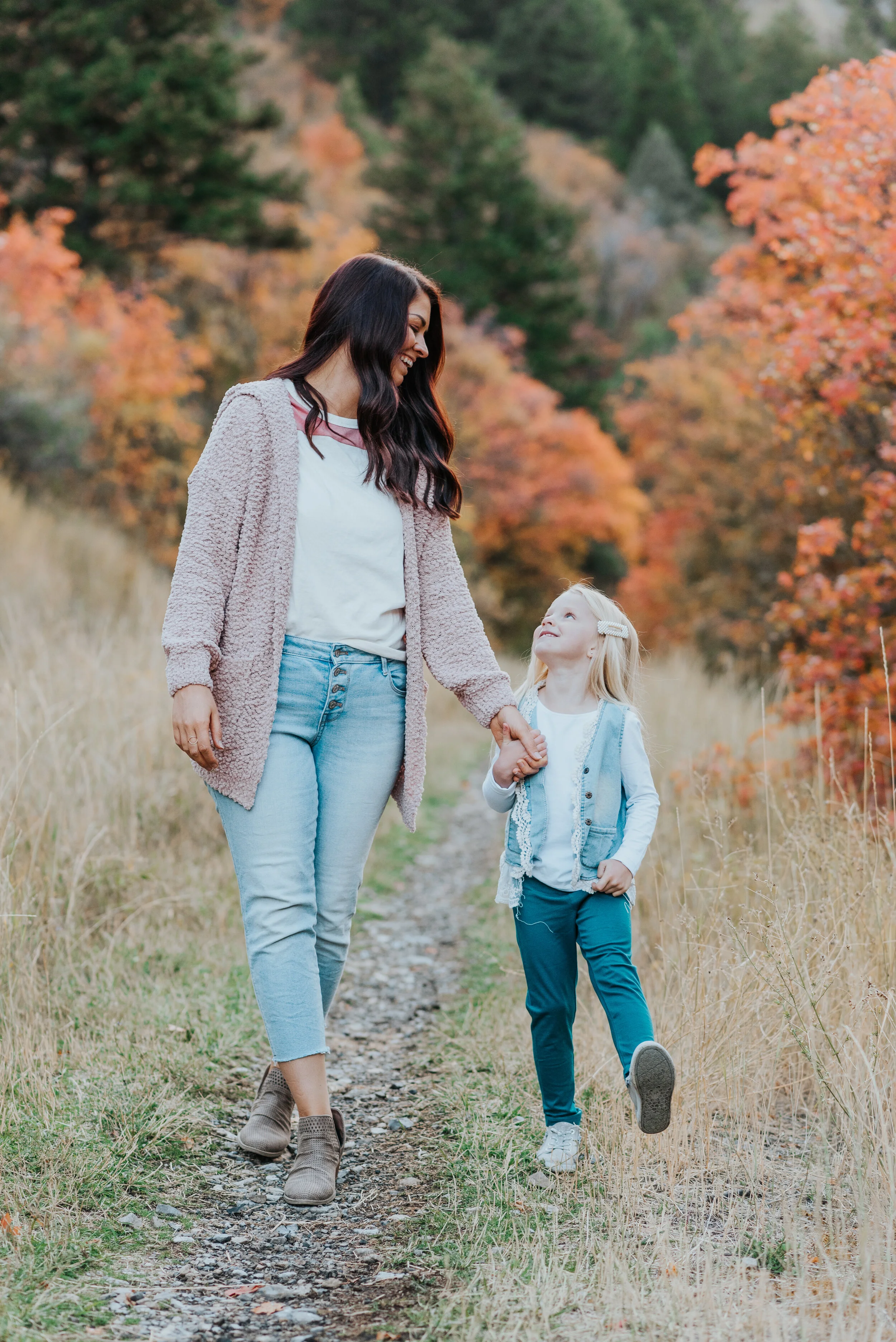  family photos in the mountains fall family photos cache valley photographer family photographer mother daughter holding hands the girls outfit inspo for family photos little moments happy moments walking down a path sweater weather candid moments #c