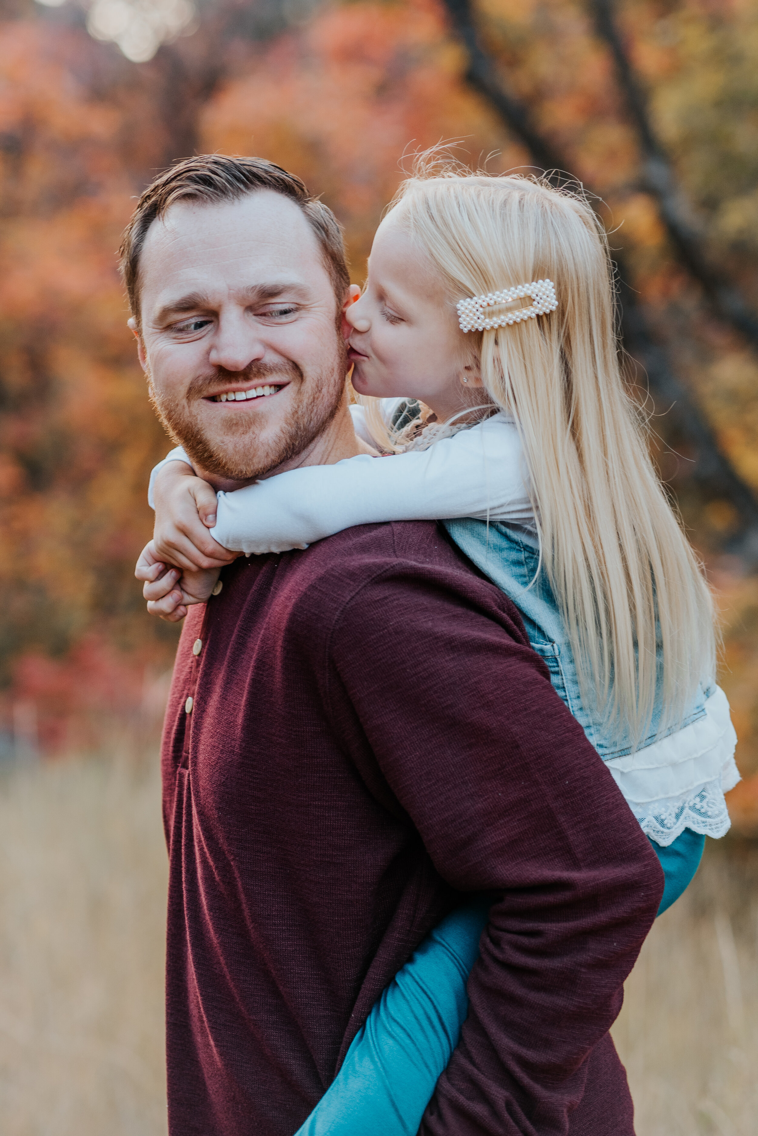  dad and daughter first love fall family photos family photos in the mountains cache valley family photographer Logan Utah family posing ideas two people posing ideas kids on back of dad fall leaves colorful photos fall outfit inspo candid moments jo