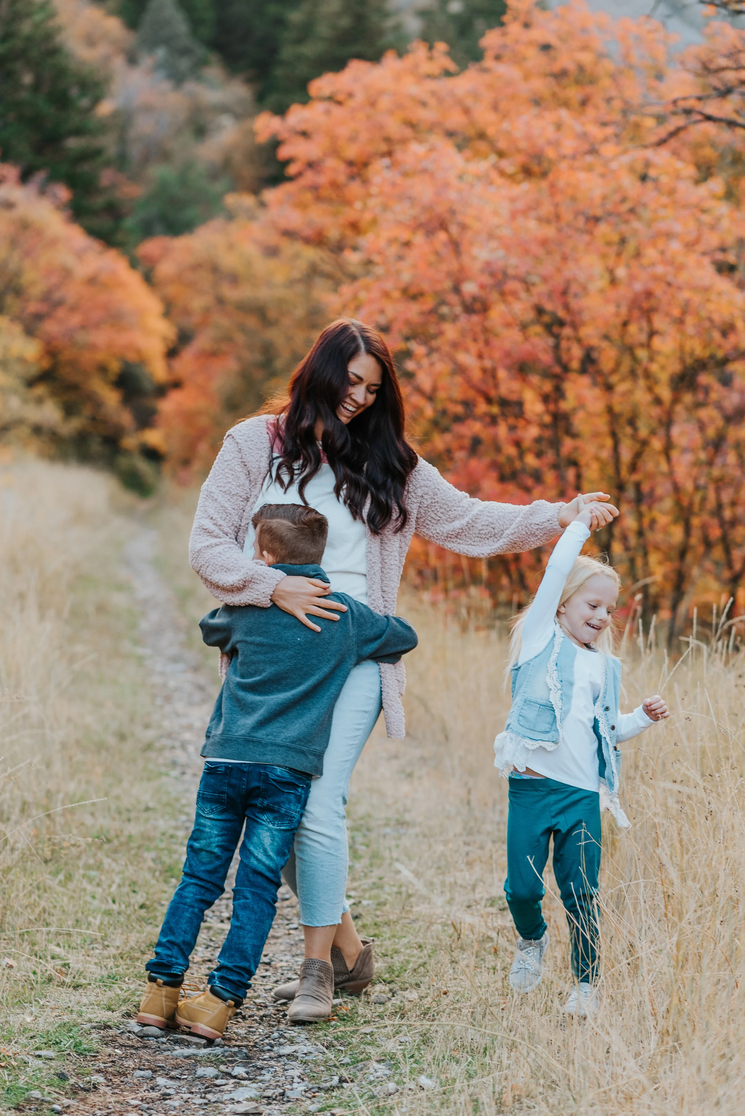  family photos family photoshoot family photographer cache valley photos in the mountains fall colors what to wear to family photoshoots mom and kids family posing ideas for three people mom playing with kids candid moments sweet moments precious mom