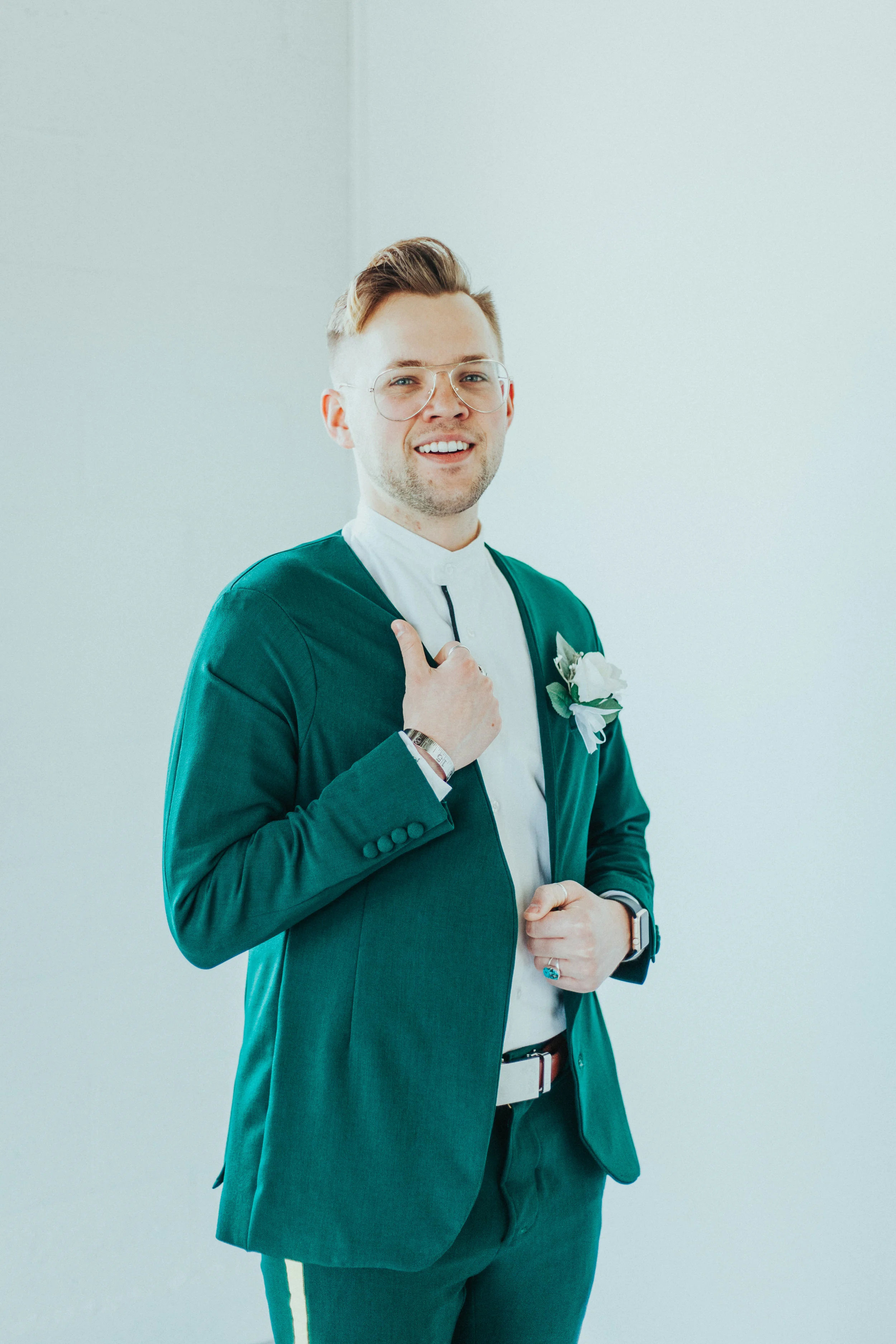  wedding morning groom emerald green wedding suit white rose boutonniere yellow striped wedding pants retro vintage glasses mens haircut studio wedding photos watch professional wedding photographer logan utah cache valley utah #StationStudio #Weddin