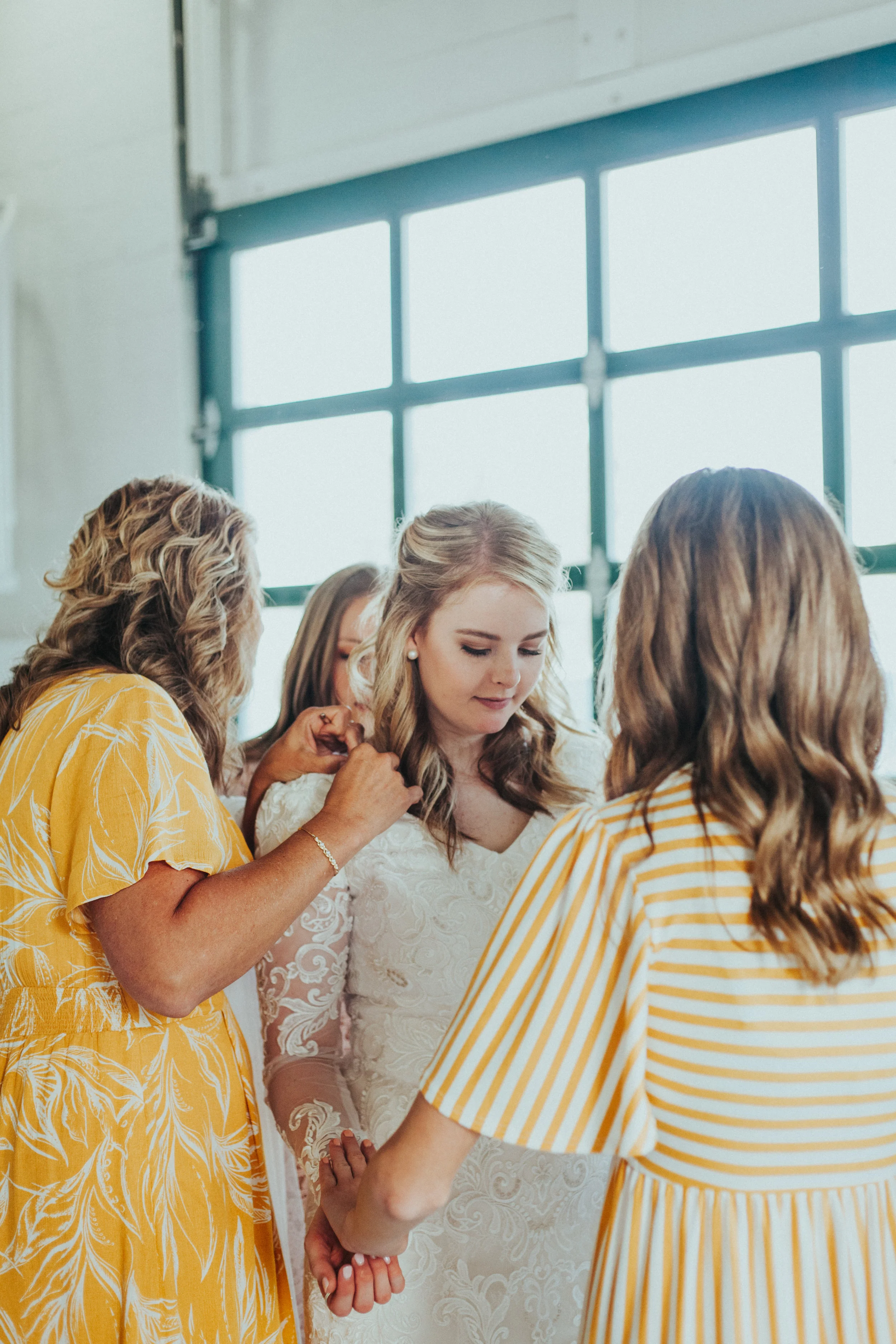  wedding morning getting ready bride mother of the bride bridesmaids studio wedding ceremony professional logan utah wedding photographer loose curled wedding hair modest lace wedding dress marigold wedding colors pearl earrrings #StationStudio #Wedd