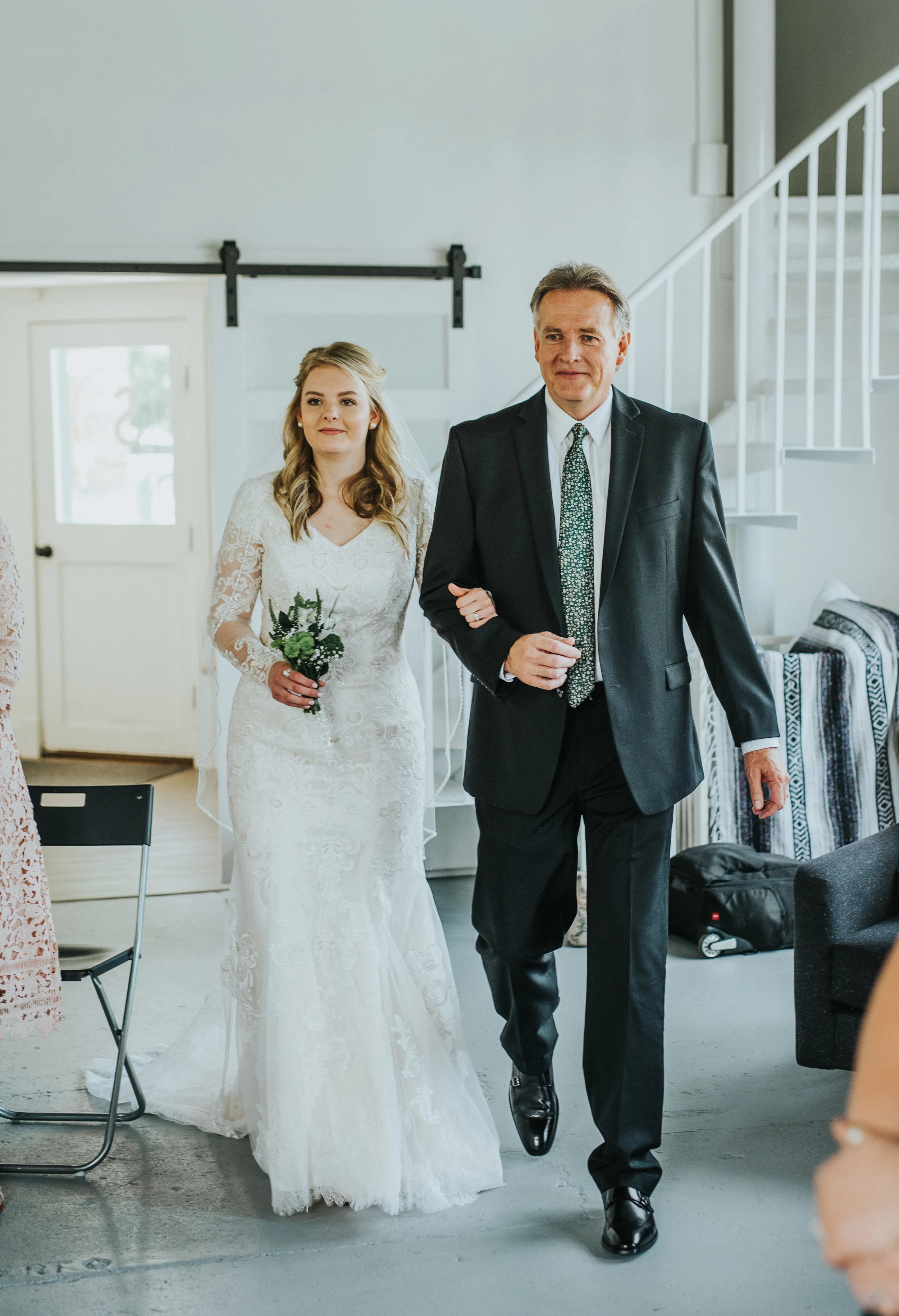  studio wedding ceremony modest long sleeved lace wedding dress father of the bride walking down the isle happy small wildflower bouquet wedding day professional logan utah wedding photographer loose wedding curls #StationStudio #WeddingCeremony #Log