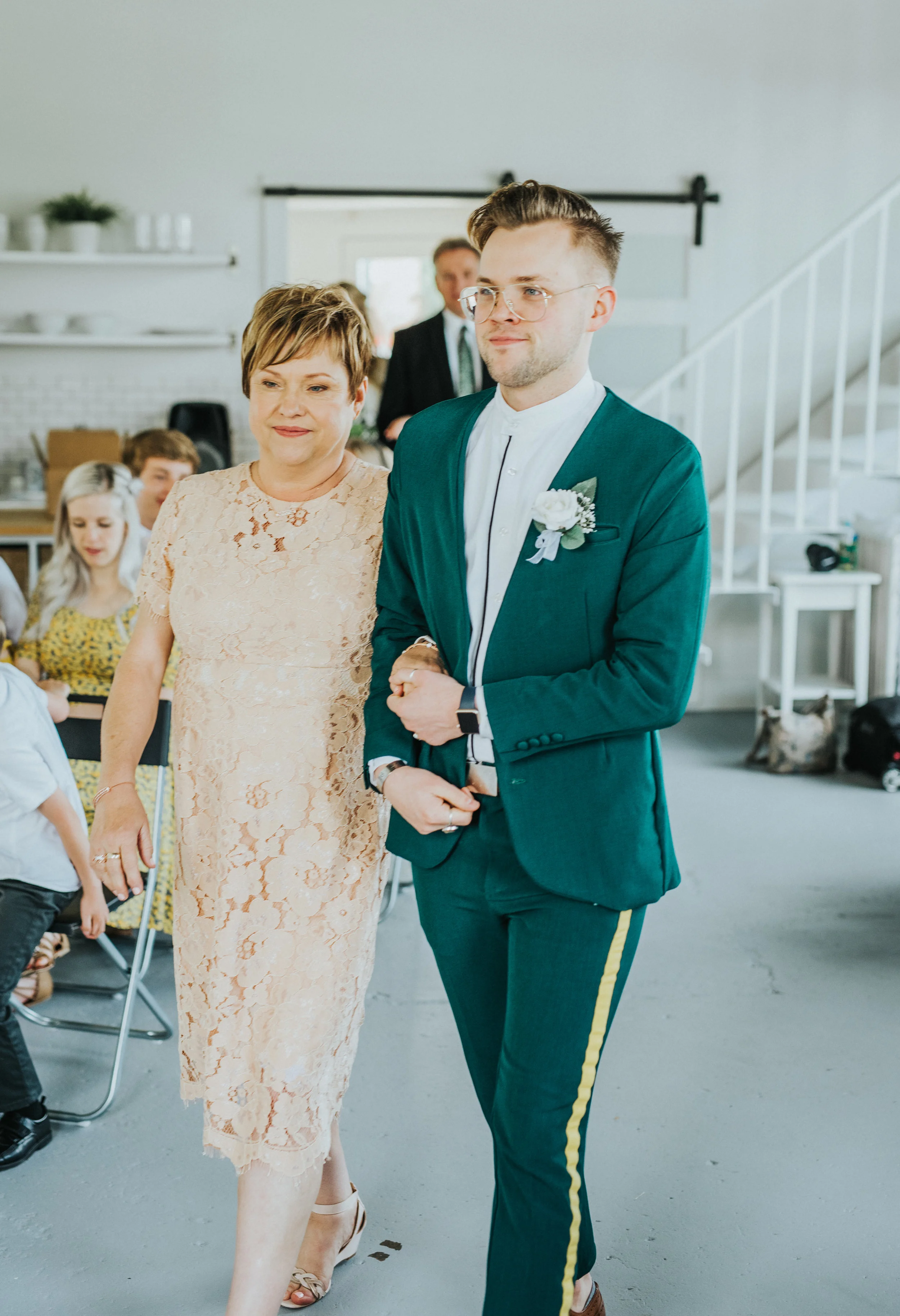  walking down the isle studio wedding ceremony mother of the groom emerald green wedding suit white rose boutonniere champagne lace modest dress professional wedding photographer logan utah #StationStudio #WeddingCeremony #Loganutahtemple #FreckleFar