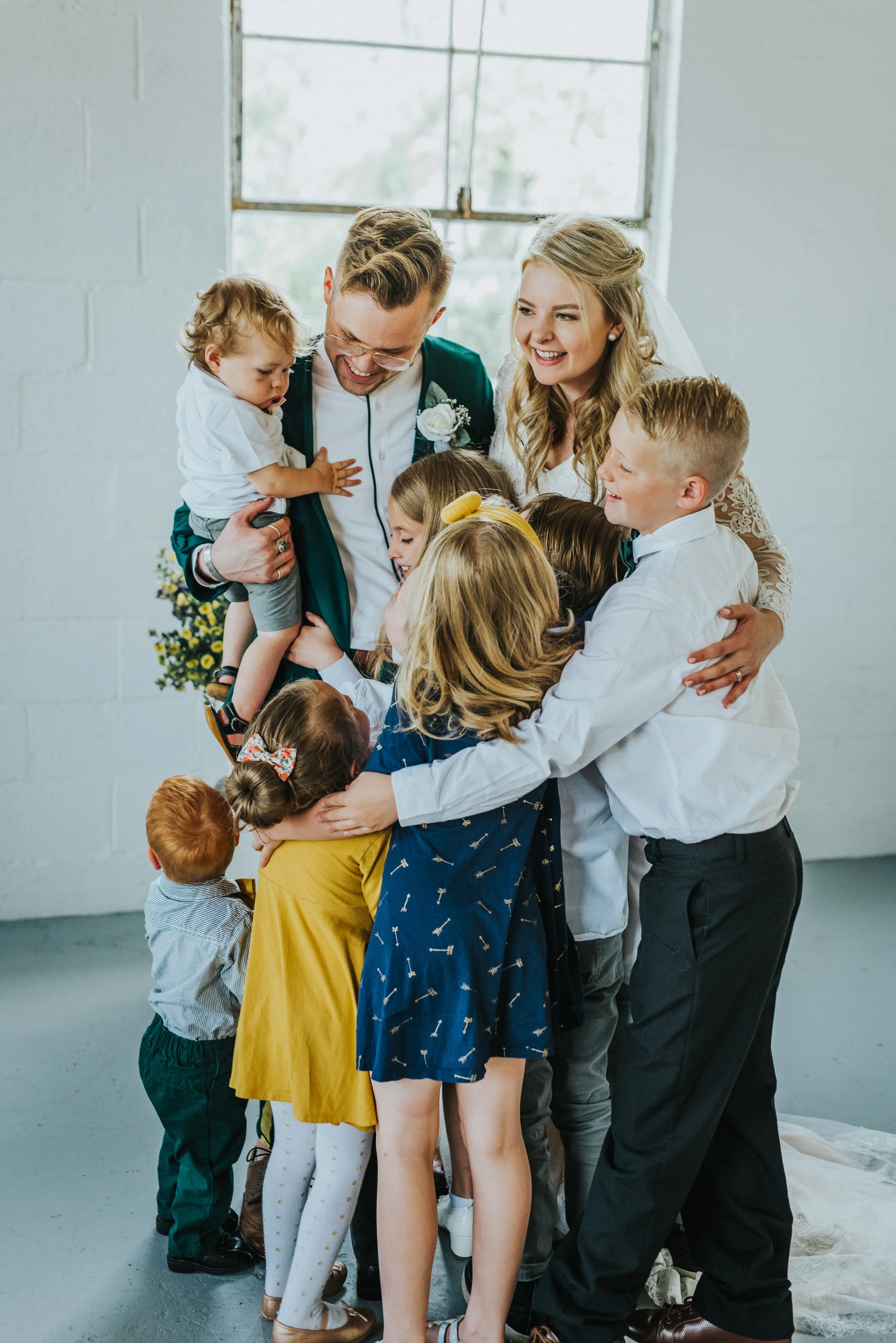  white brick studio minimalist wedding ceremony civil marriage just married nieces and nephew hugging happy celebrating professional logan utah wedding photographer cache valley utah natural light studio #StationStudio #WeddingCeremony #Loganutahtemp