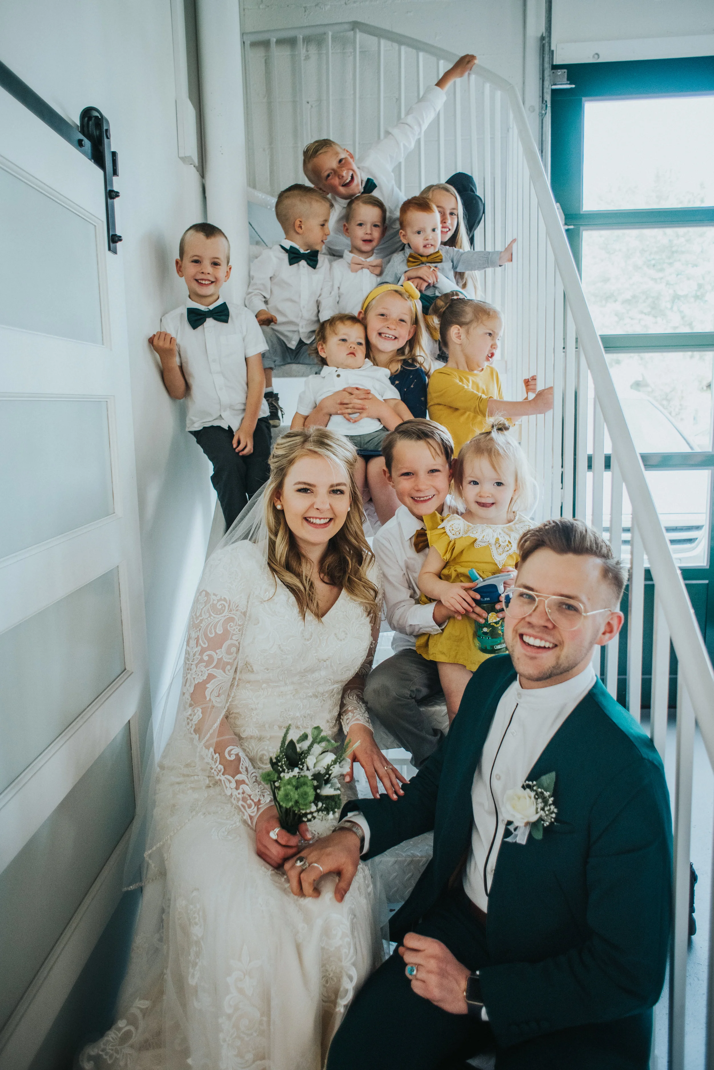  white brick studio minimalist wedding ceremony civil marriage just married happy celebrating professional logan utah wedding photographer extended family staircase photo natural light studio #StationStudio #WeddingCeremony #Loganutahtemple #FreckleF