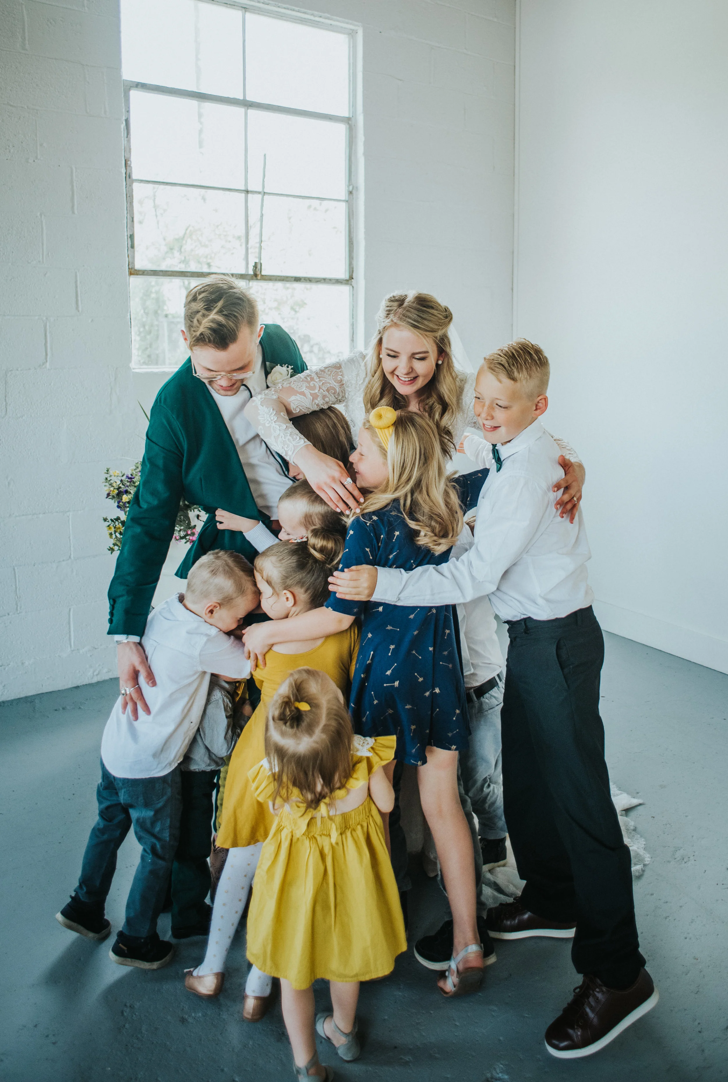  white brick studio minimalist wedding ceremony civil marriage just married nieces and nephew hugging happy celebrating professional logan utah wedding photographer #StationStudio #WeddingCeremony #Loganutahtemple #FreckleFarm #cachevalleyutah #utah 