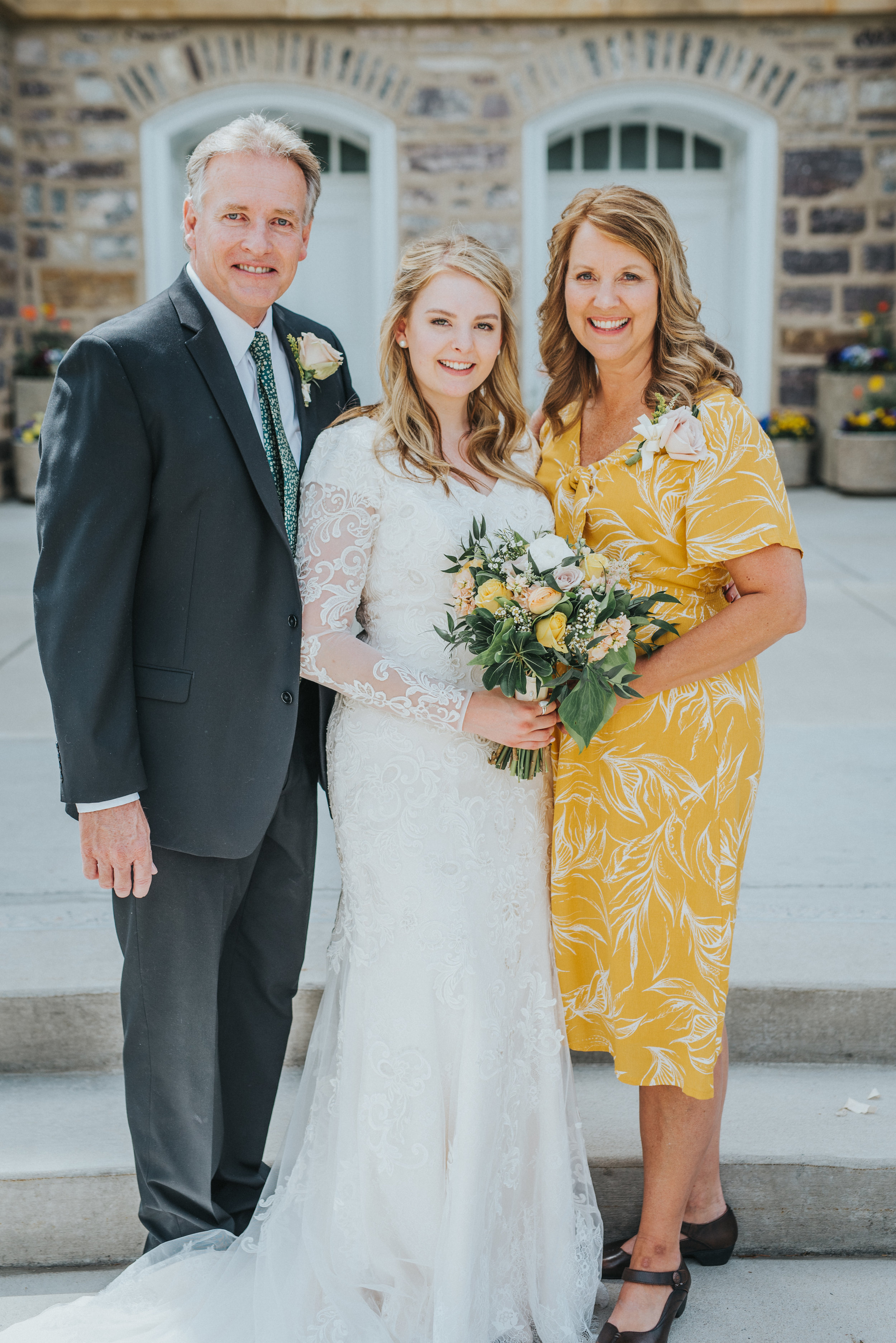  just married bride parents of the bride logan utah lds temple sealing modest lace long sleeved wedding dress marigold mother of the bride dress happy smiling professional logan utah wedding photographer #StationStudio #WeddingCeremony #Loganutahtemp
