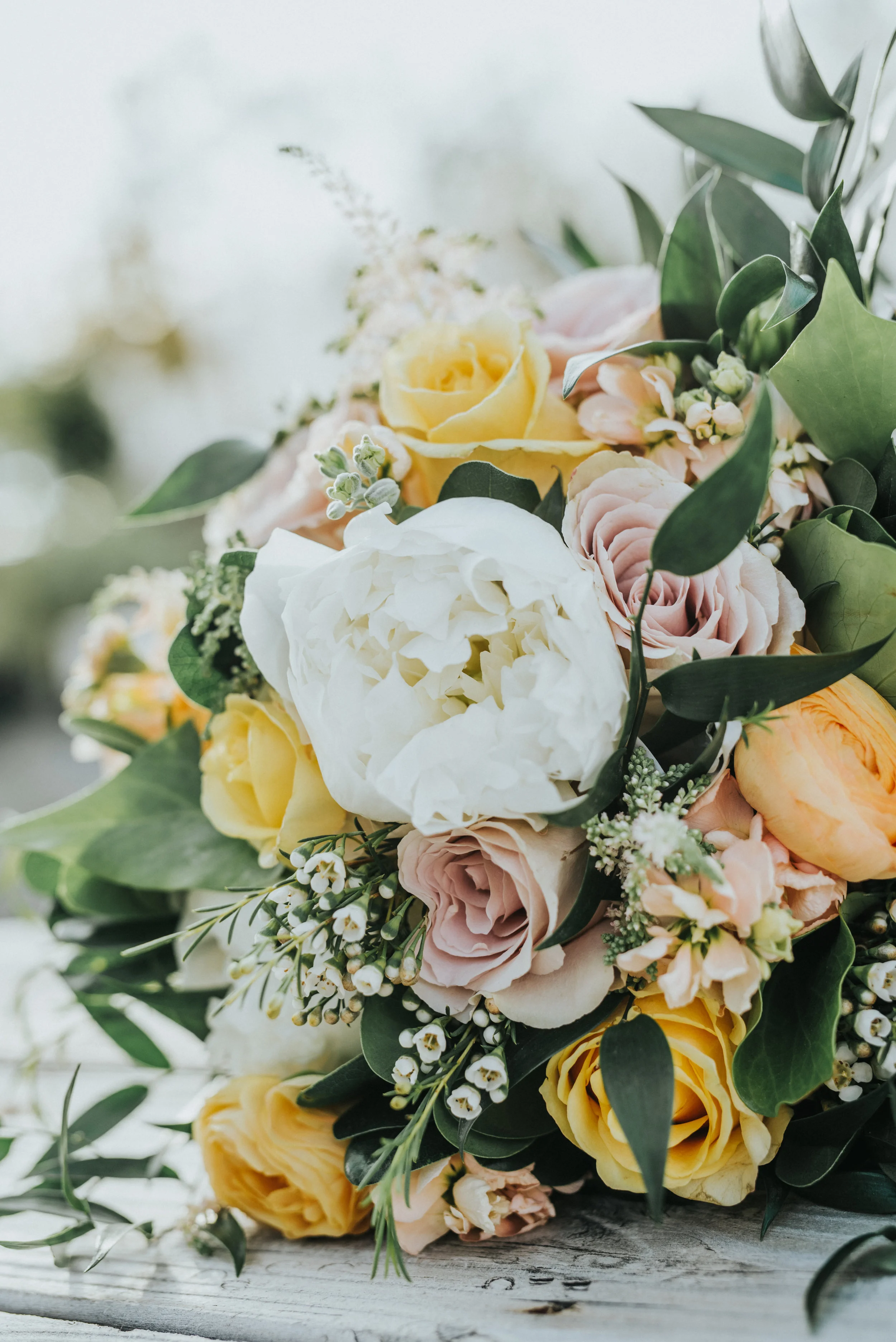  yellow and white wedding bouquet wedding details professional logan utah wedding photographer freckle farm outdoor wedding reception cache valley utah blurred background #StationStudio #WeddingCeremony #Loganutahtemple #FreckleFarm #cachevalleyutah 