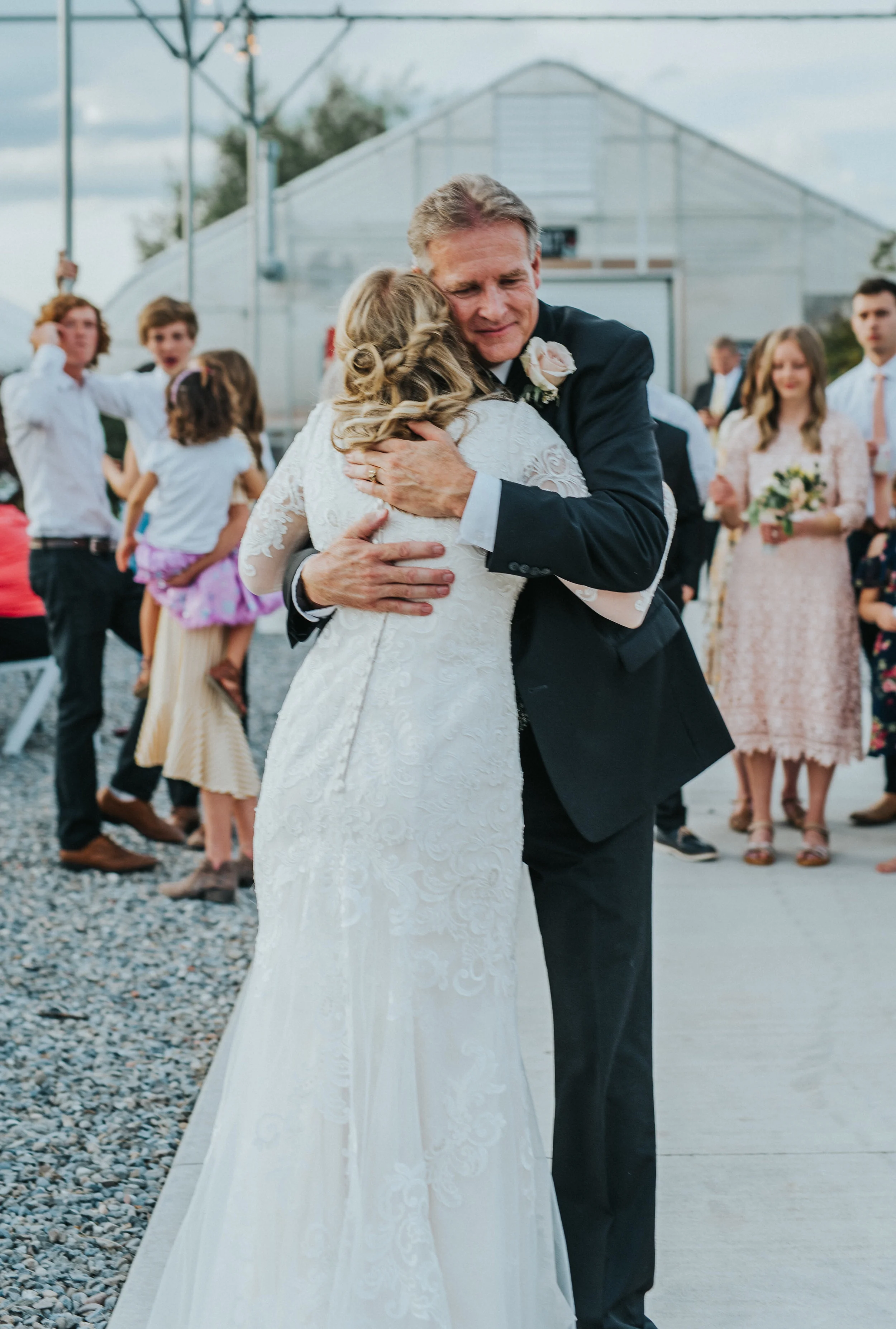  freckle farm outdoor wedding ceremony gravel ground father daughter dance sentimental hugging happy giving away loose half wedding updo buttoned wedding dress lace modest lds professional logan utah wedding photographer candid #StationStudio #Weddin