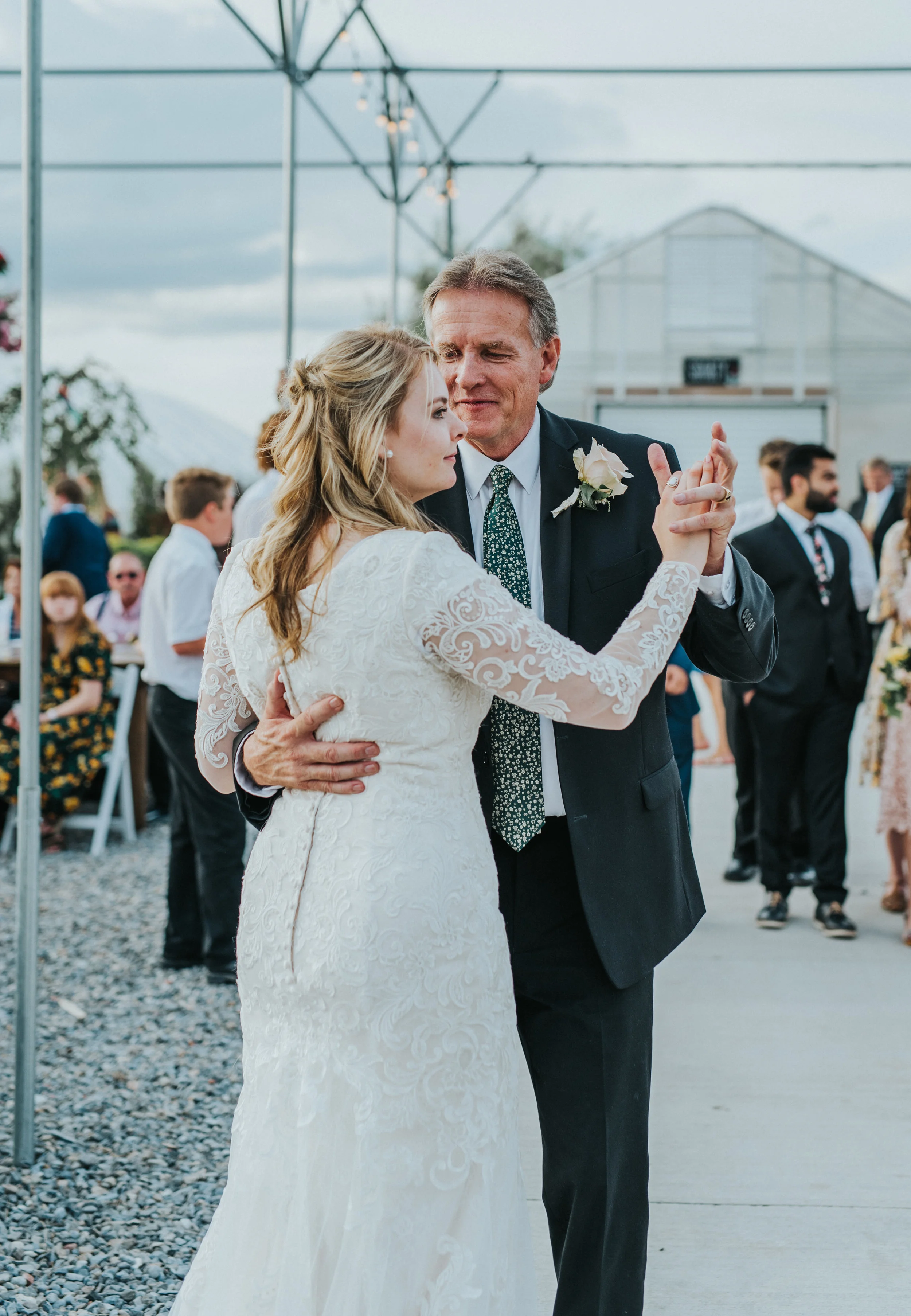 father daughter dance half wedding updo modest lace long sleeved wedding dress loose wedding curls freckle farm outdoor reception professional logan utah wedding photographer gravel ground logan utah father of the bride boutonniere #StationStudio #W