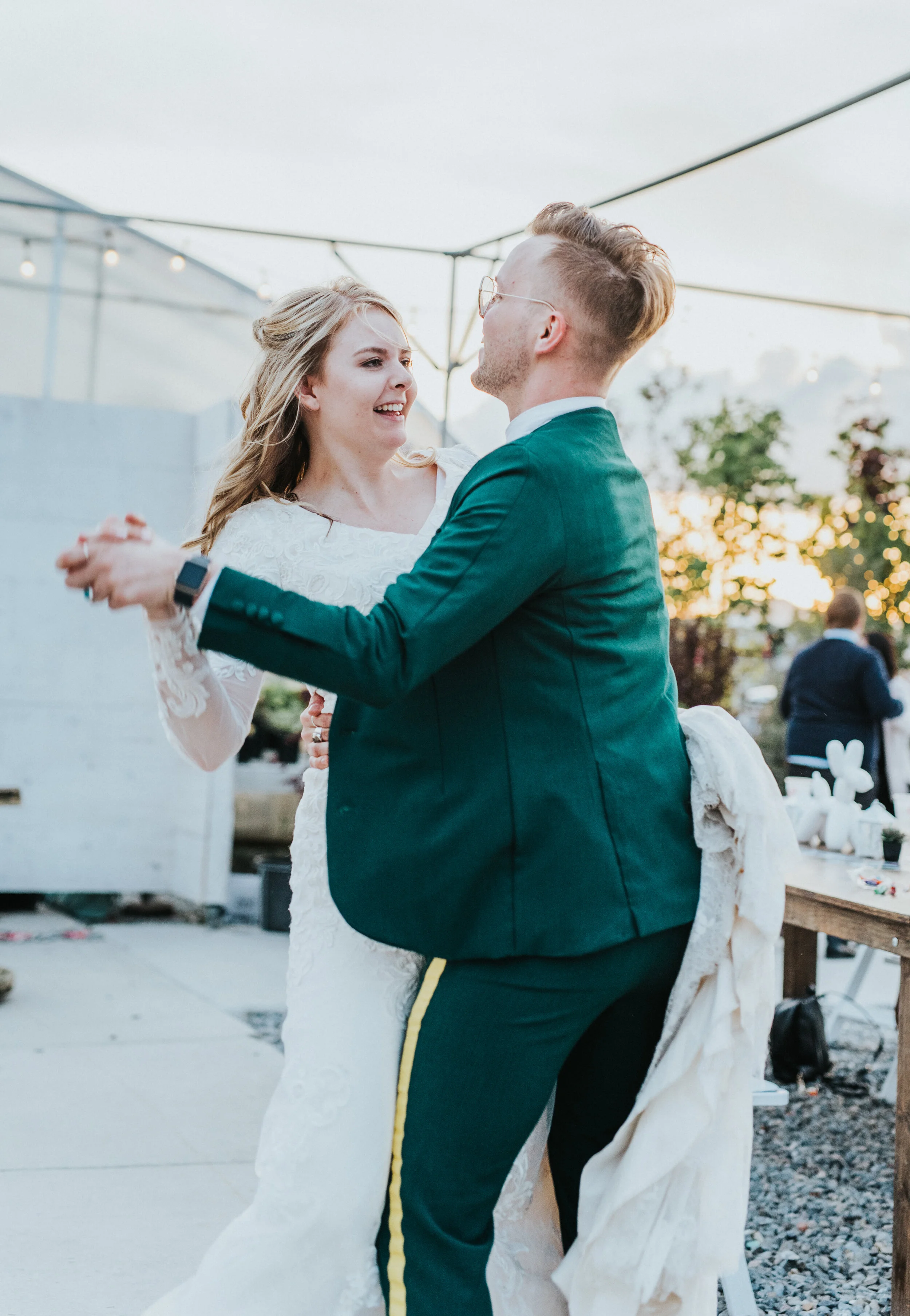  first dance freckle farm outdoor wedding reception happy twirling holding wedding train retro wedding suit emerald green half wedding updo inspiration professional cache valley utah wedding photographer candid moments string lights #StationStudio #W