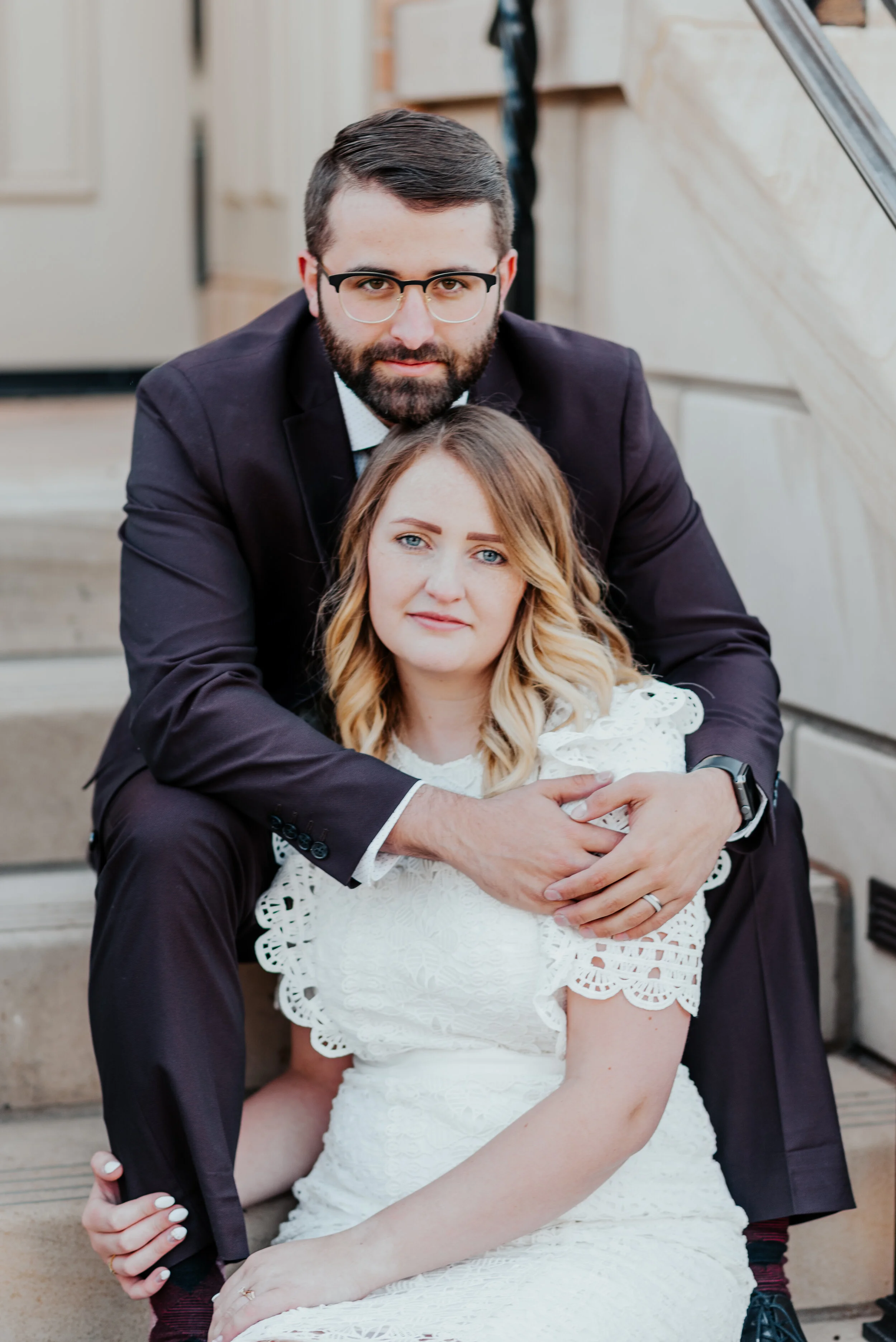 burgundy wedding duit formal wedding photos provo city center temple wedding stairs sitting hugging wedding bands short sleeved lace wedding dress ombre loose curled hair vintage glasses provo utah wedding photographer #utahvalleyweddingphotographer