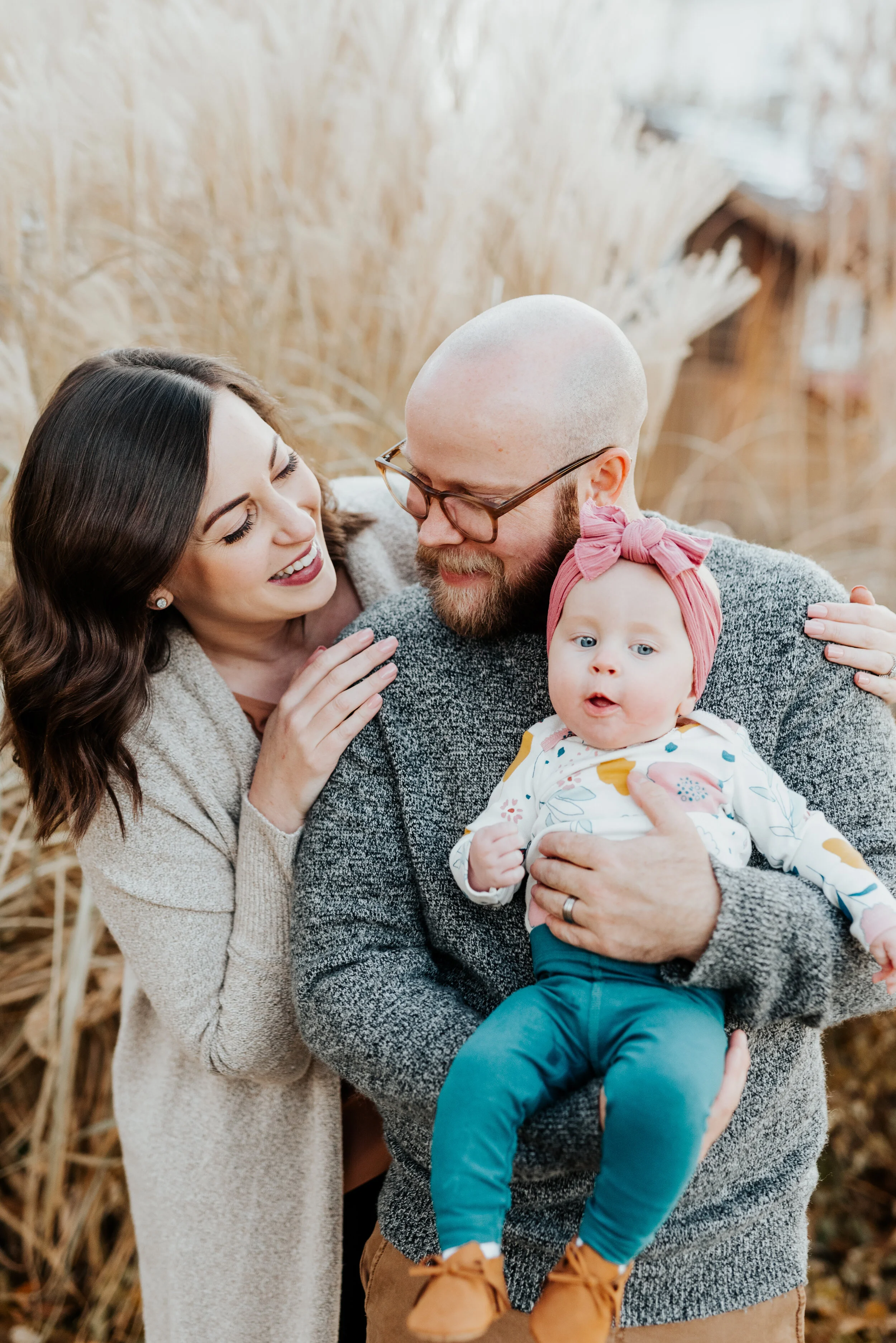  tall fall grass fall family photos outfit inspiration sweaters short wavy hair retro mens glasses infant baby girl pink baby bling headband professional cache valley utah family photographer logan utah hugging happy authentic photo posing #loganutah