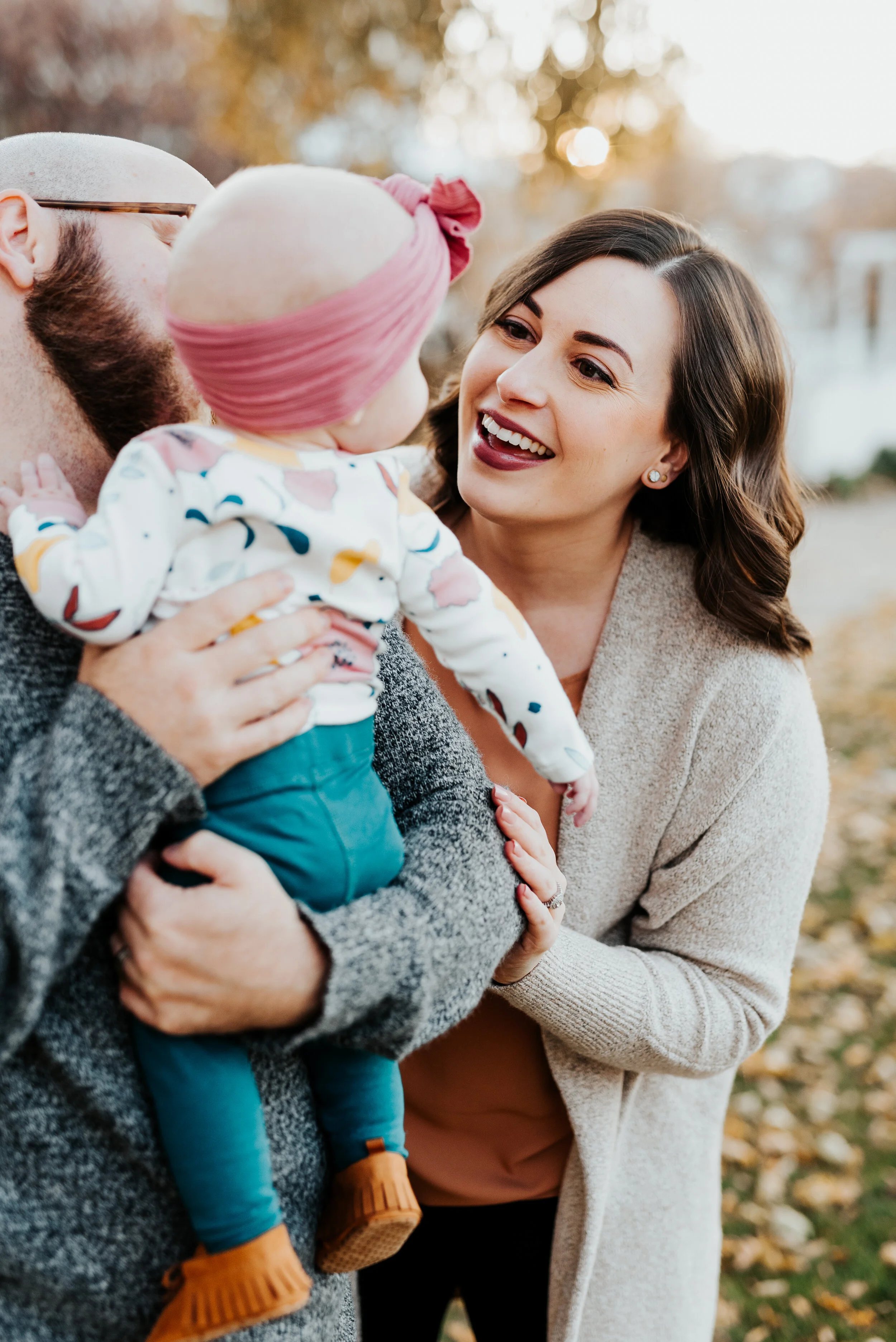 daddy daughter photos holding baby baby smiles baby looking at mom pink baby bling bow brown baby girl moccasins fall family photos sweater best professional family photographer logan utah #loganutah #loganutahphotographer #cachevalleyphotographer #
