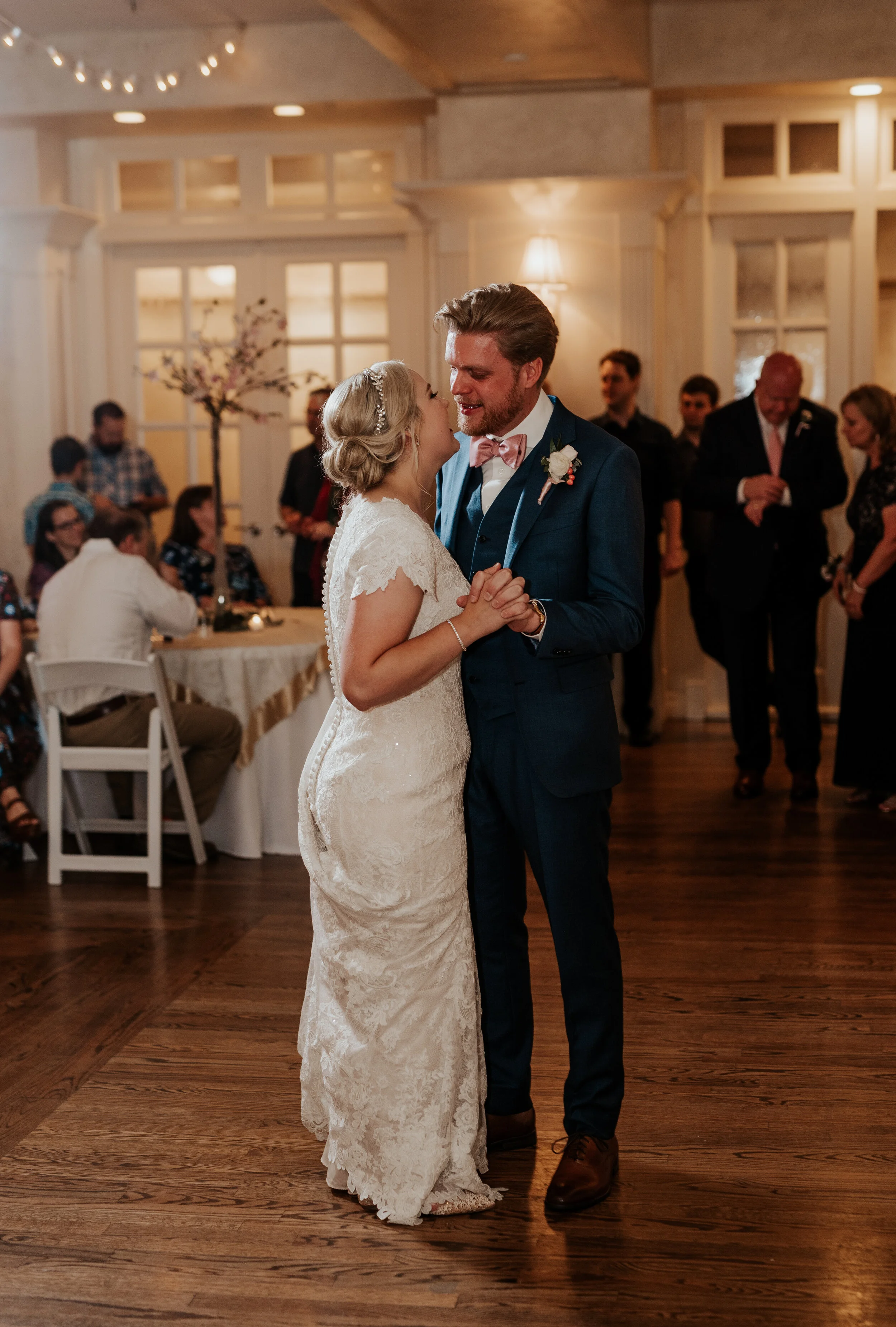  utah photographer utah wedding reception ideas reception center ideas the manor at the riverwooods wedding day cetails modest wedding dress inspo husband and wife three piece suit blue and pink wedding color ideas romantic couple first dance intimat