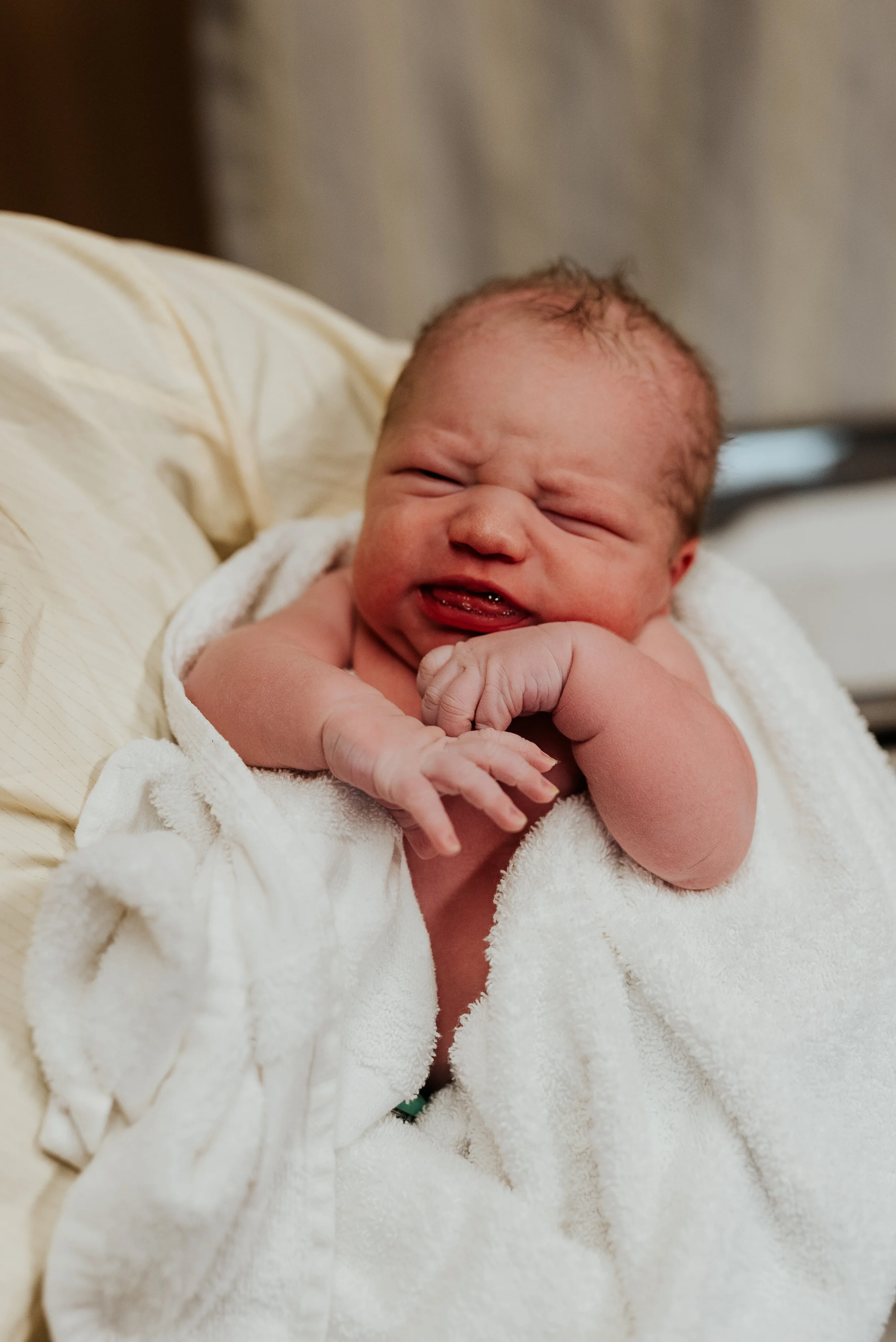  Pink skinned newborn baby boy wrapped in a fluffy white towel greeting the world fresh from heaven. hospital pictures of a brand new baby birth photo session newborn photographer in cache valley logan utah professional birth story photographer #kris