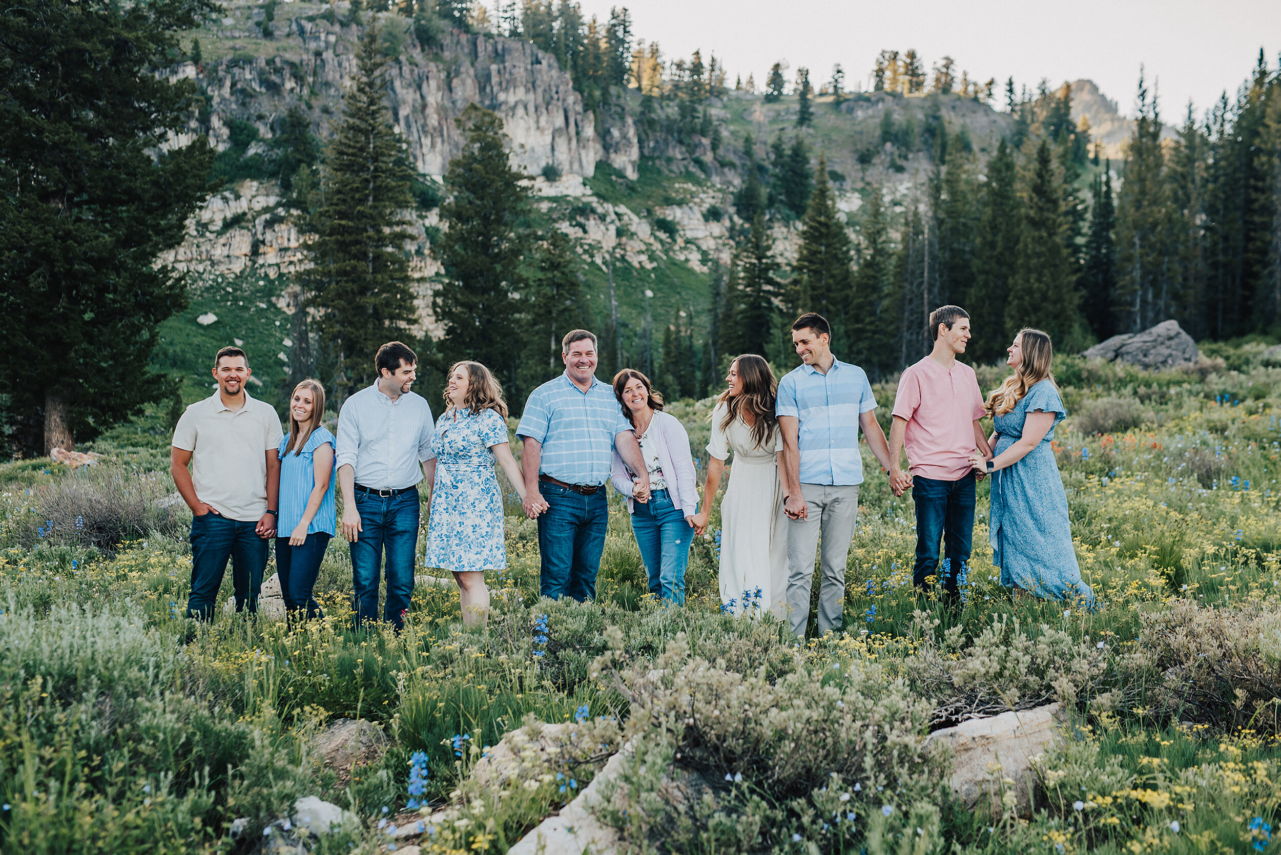 Gorgeous family photoshoot amongst pine trees and wild flowers up Logan Canyon. Logan Utah family photographer Kristi Alyse photography Tony Grove forest nature photos Logan canyon light blue family photos wild flowers grand parents children parents…