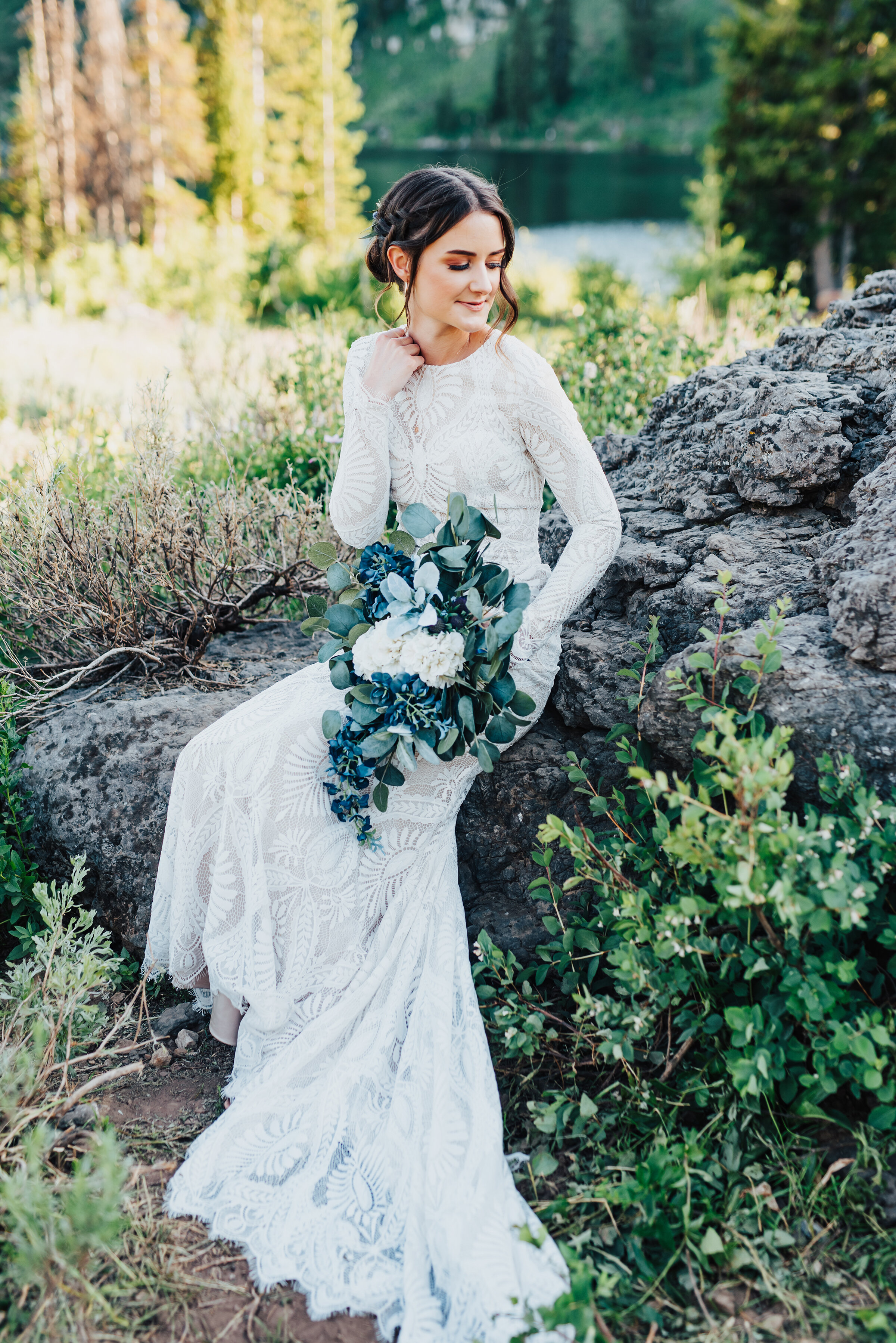  Glowing bride holding handpicked greenery during this lovely bridal session up Logan canyon. Kristi Alyse photography Logan Utah wedding photographer forest nature dreamy formals Logan canyon Tony Grove scenic bridals Northern Utah photographer Utah
