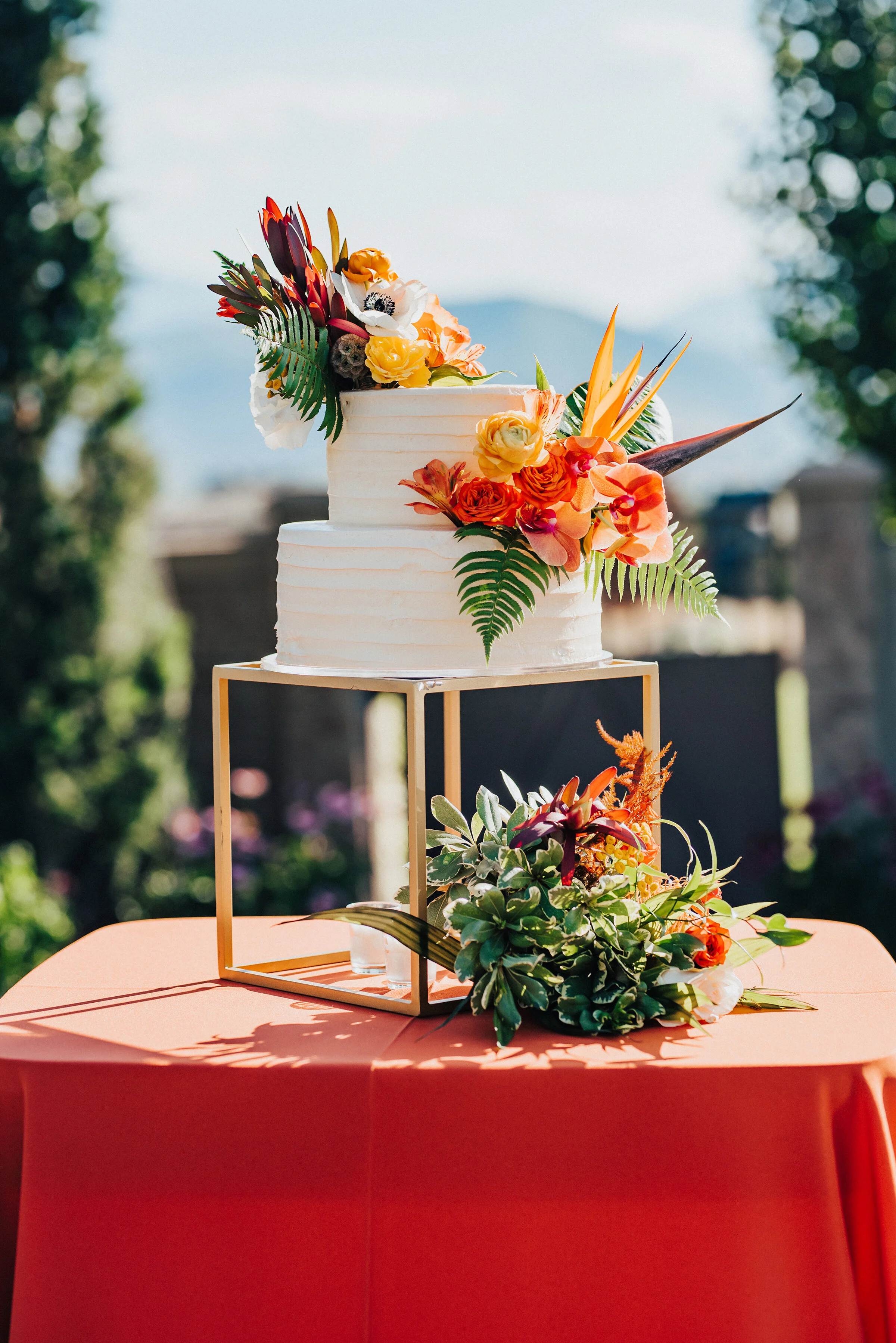  Gorgeous two-tier wedding cake with floral accents displayed at this lovely backyard wedding in Park City. Kristi Alyse Photography Logan Utah photographer Park City wedding photographer Drive-Thru wedding COVID wedding neon signs socially distant w