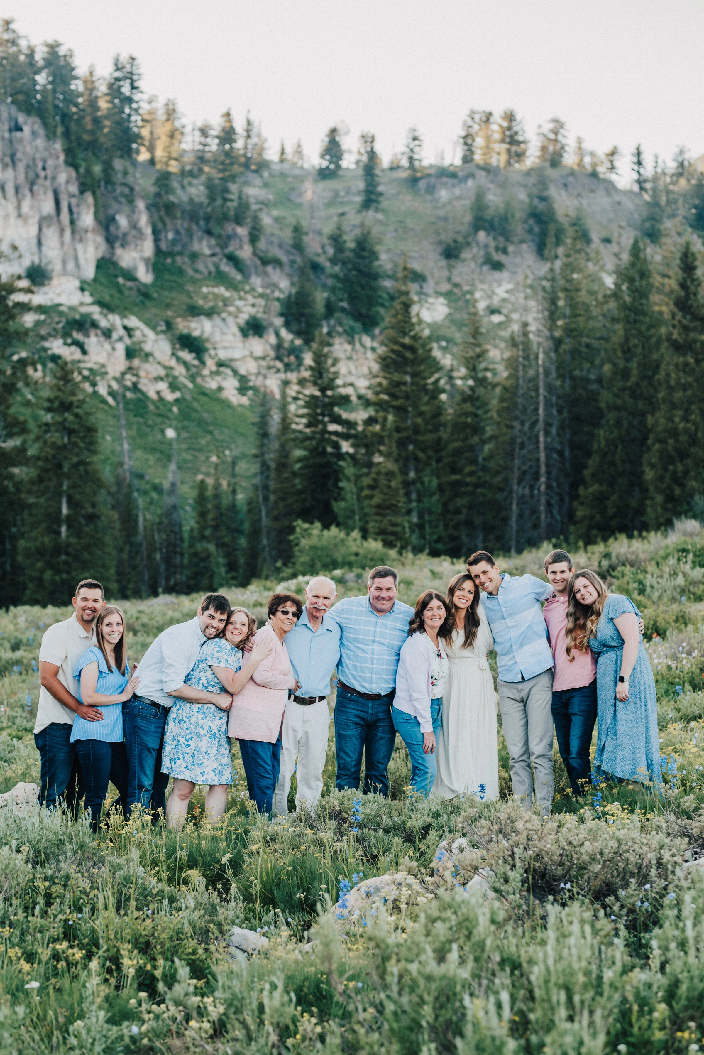  Delightful family photo session surrounded by pine trees and wild flowers up Logan canyon at Tony Grove. Logan Utah family photographer Kristi Alyse photography Tony Grove forest nature photos Logan canyon light blue family photos wild flowers grand