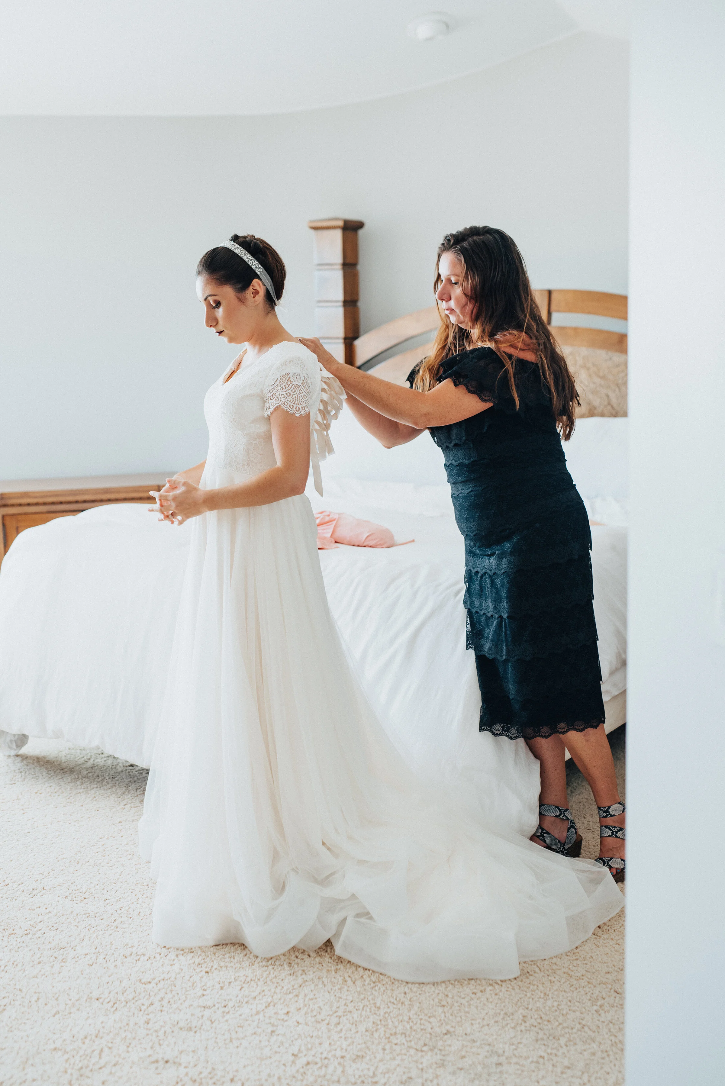  Mother of the bride helping her daughter get ready for her wedding day in Laguna Beach. Kristi Alyse photography Laguna Beach wedding California brides Logan Utah wedding photographer backyard wedding destination photographer covid wedding bride and
